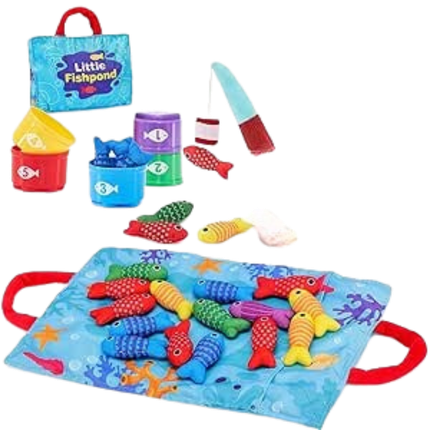 Assorted fishing toys, including colorful fish and fishing rods, on a playful blue mat with ocean-themed patterns and a small shopping bag in the background.