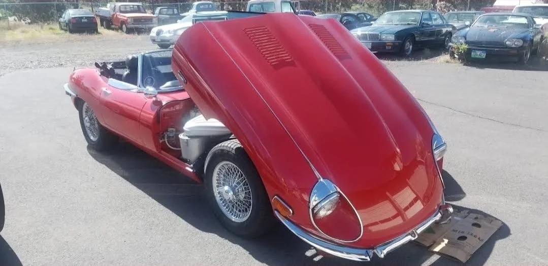 Classic Jaguar E-Type (XKE) undergoing mechanical stewardship and engine tuning at Chuck's Auto Shop in Bend, Oregon.