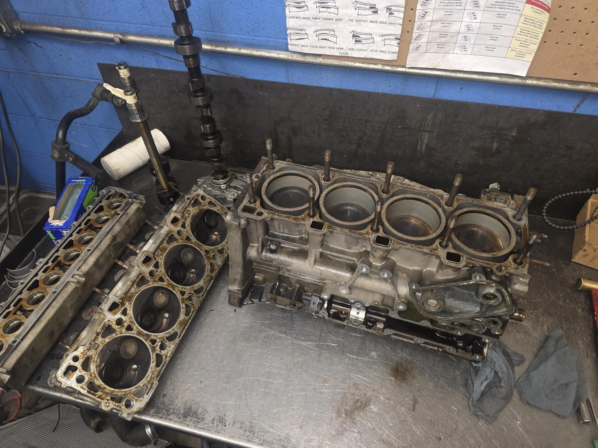 Full forensic teardown of a Porsche 944 inline-four; Alusil block and head assembly prepped for surgical valve stem seal restoration at Chuck's Auto Shop Inc.