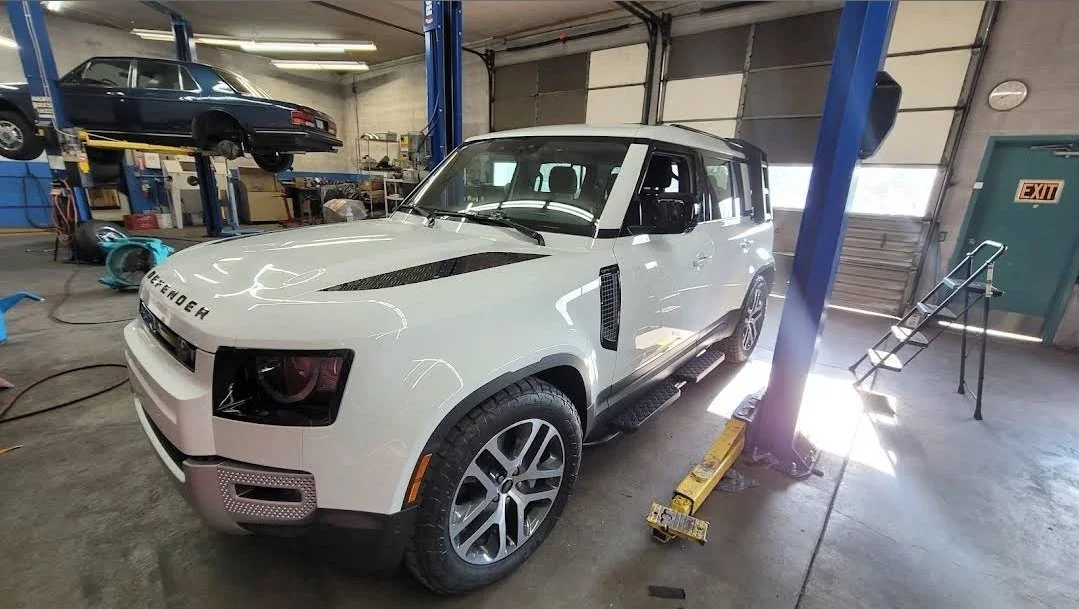 Land Rover Defender undergoing routine maintenance and rocker step installation at Chucks Auto Shop Inc, in Bend Oregon