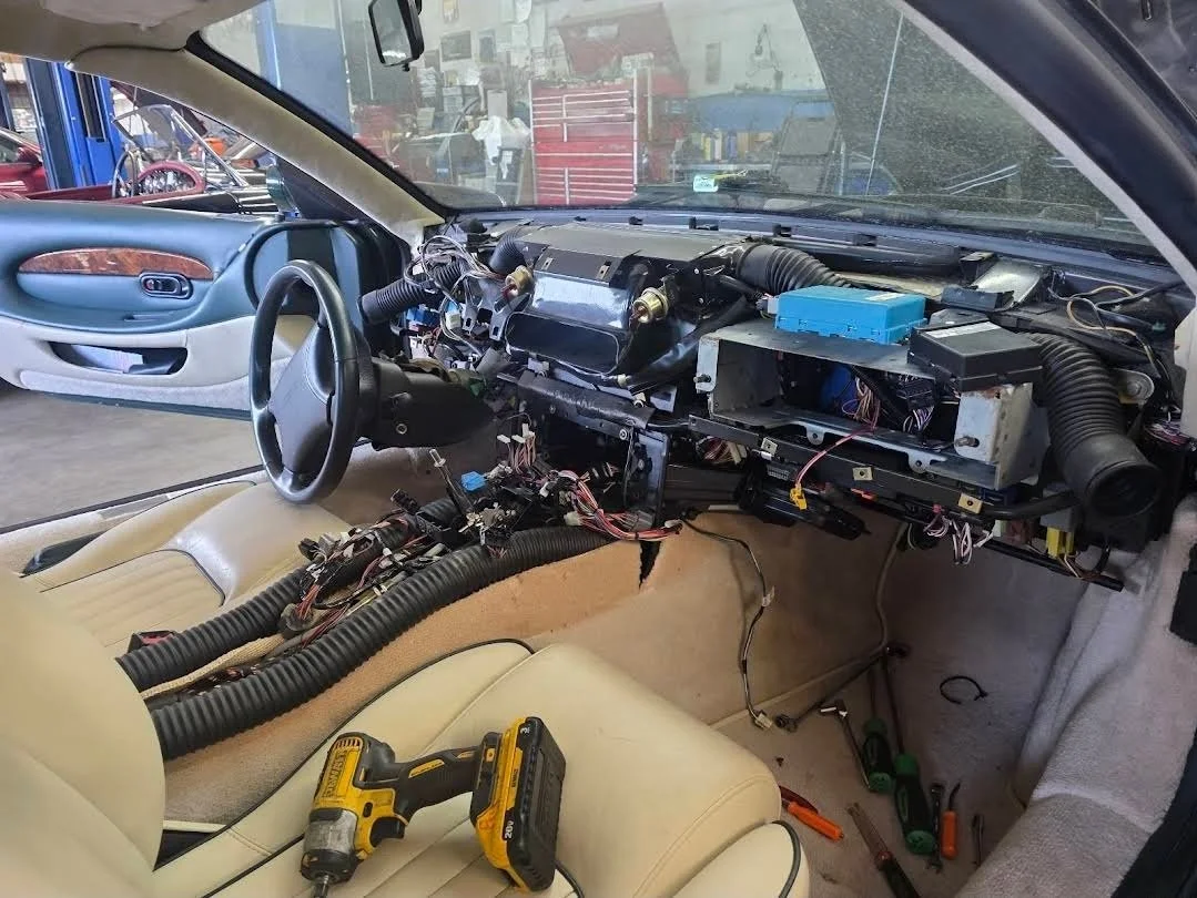 Aston Martin with its dash removed for AC Condenser Core Replacement at Chucks Auto Shop Inc. in Bend Oregon
