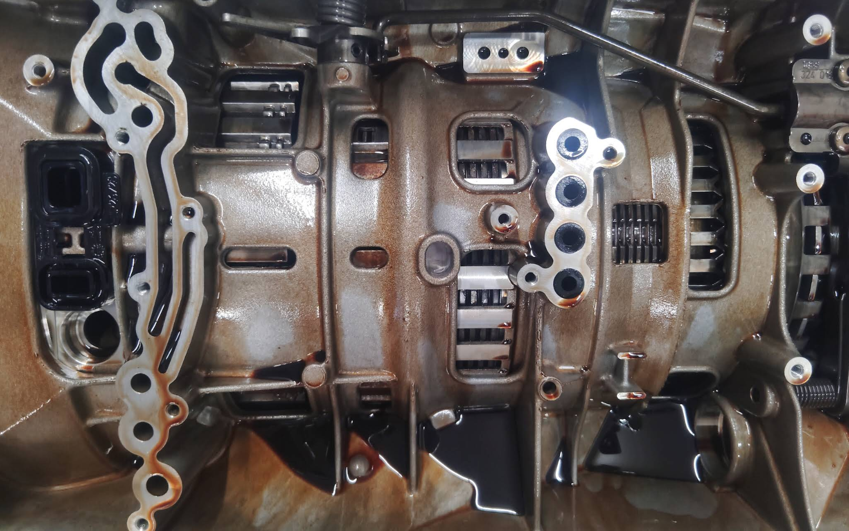 ZF 8HP with the valve body removed getting inspected for excessive wear and early signs of failure.
