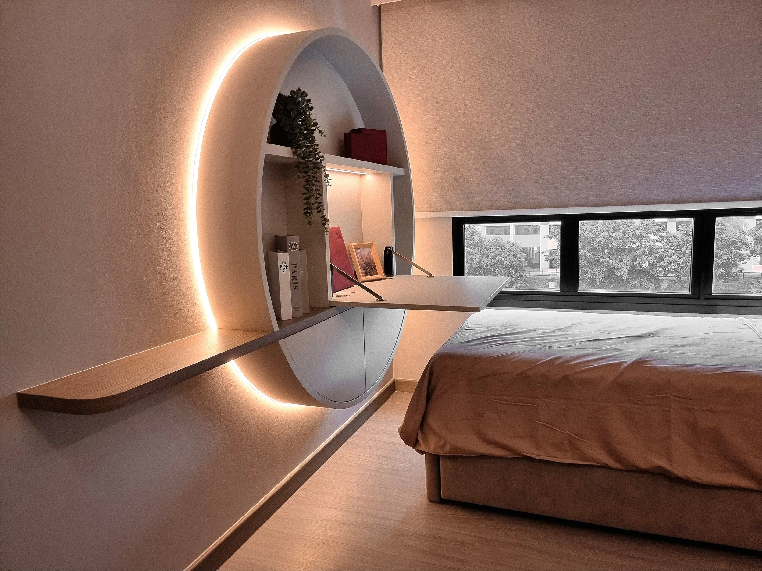 Whiteboard interior design studio - Modern bedroom with a floating white desk, built-in bookshelves with books and decor, soft wallpaper, and a large window showing trees outside.