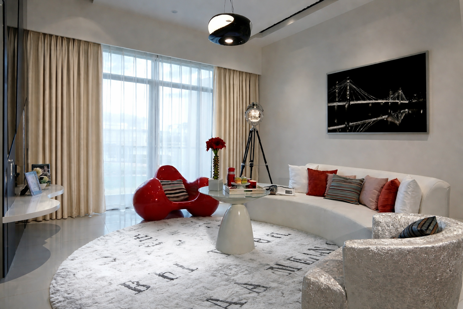 Modern living room with white curved sofa, decorative pillows, red accent chair, round coffee table, and floor lamp; large window with beige curtains; black and white cityscape photograph on wall.