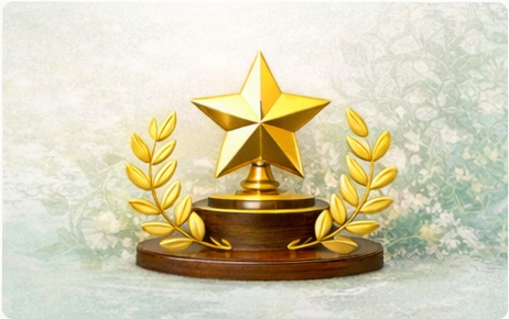 Golden trophy with a star on top, decorated with gold laurel branches on a wooden base.