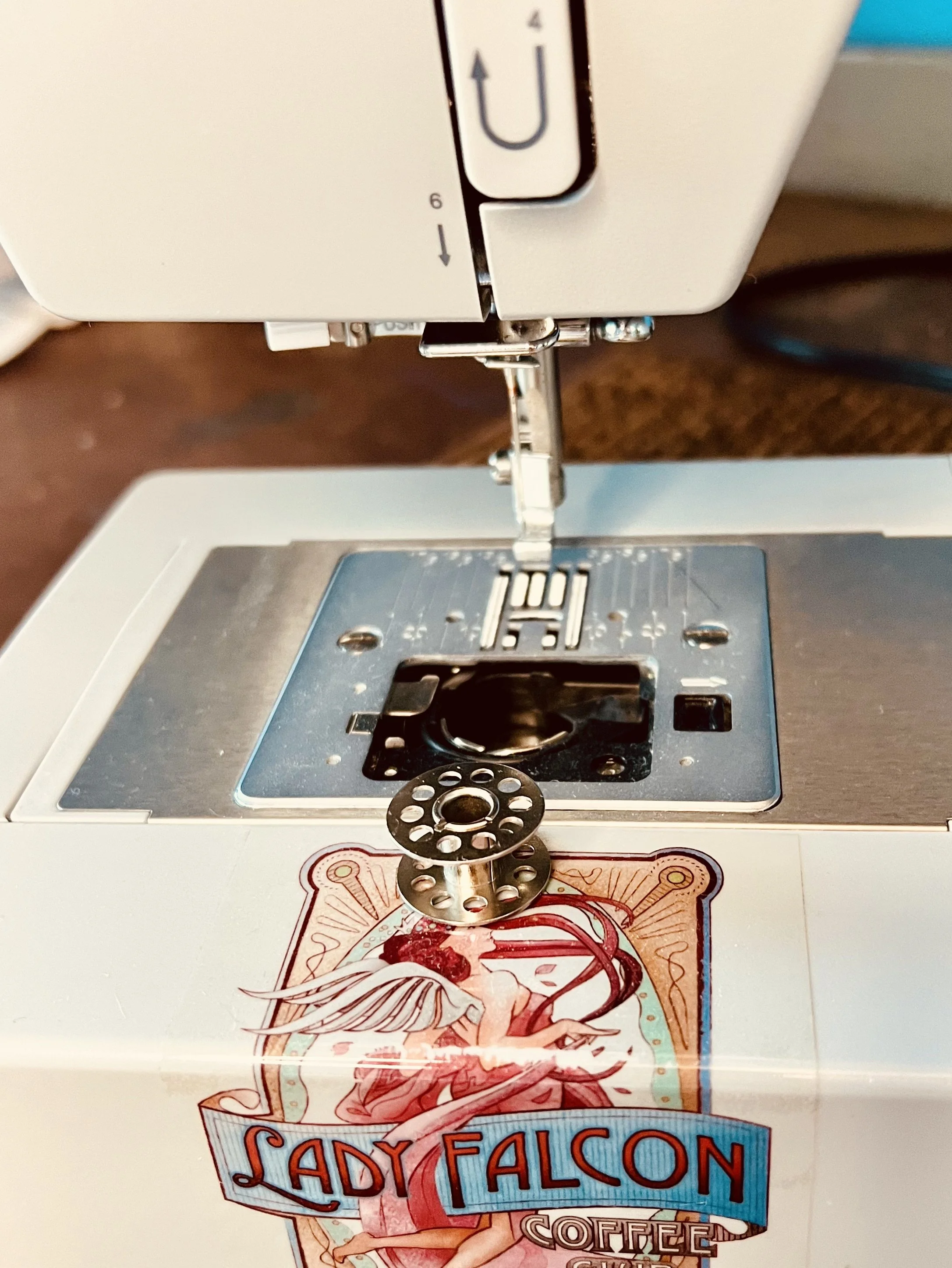 Singer Heavy Duty sewing machine with the correct bobbin placed next to the needle plate