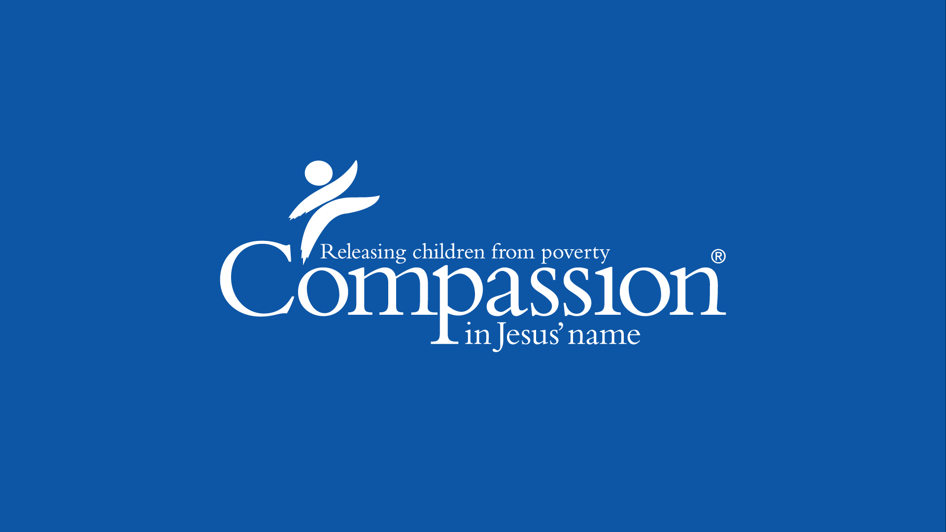 Blue background with white text and logo for Compassion, a charity organization. The text reads 'Releasing children from poverty in Jesus' name' with the word 'Compassion' prominently displayed.