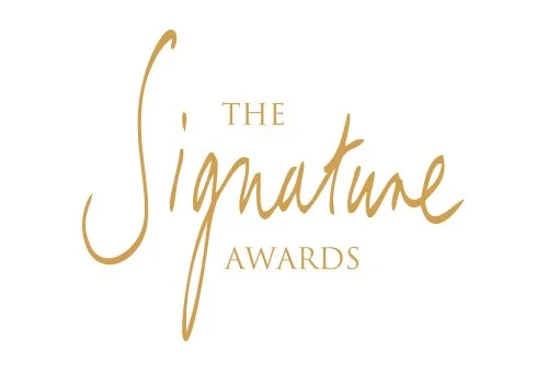 Logo of The Signature Awards with elegant gold text on a white background.