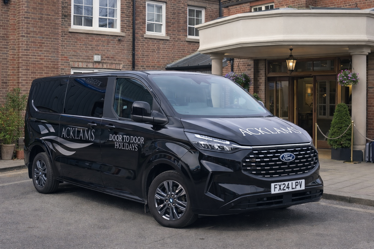 Black vehicle parked outside a brick building with a rounded entrance.