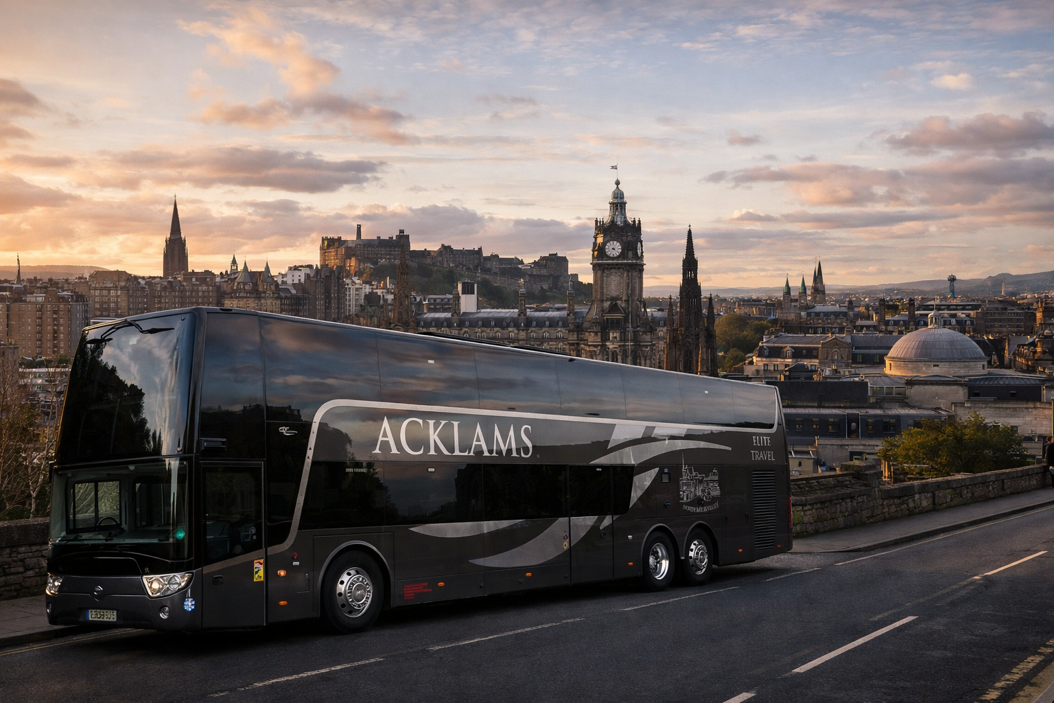 Black double-decker bus with 'ACKLAMS' logo parked on a street with a city skyline featuring historic buildings and a castle in the background during sunset.
