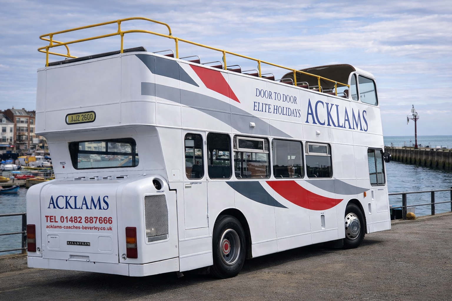 Double-decker bus with sky and harbor in the background, advertising from Acklams with contact info and slogan