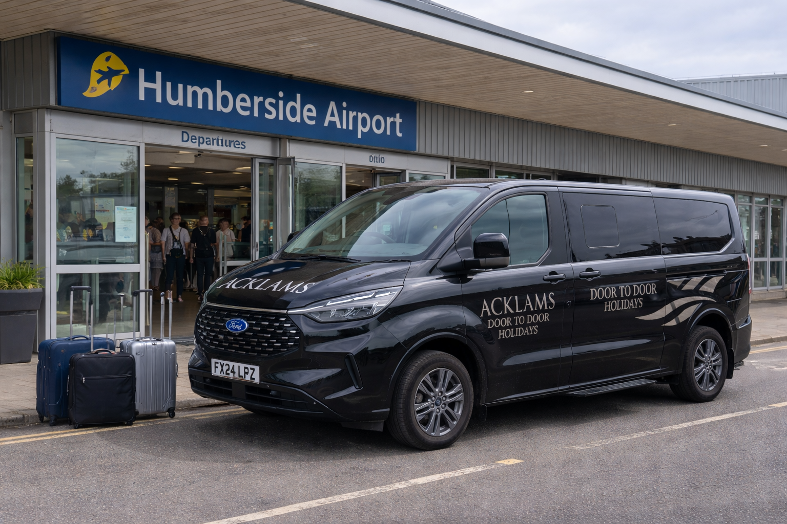 A black van parked in front of Humberside Airport entrance with two pieces of luggage beside it, and people inside the terminal visible through the glass entrance.