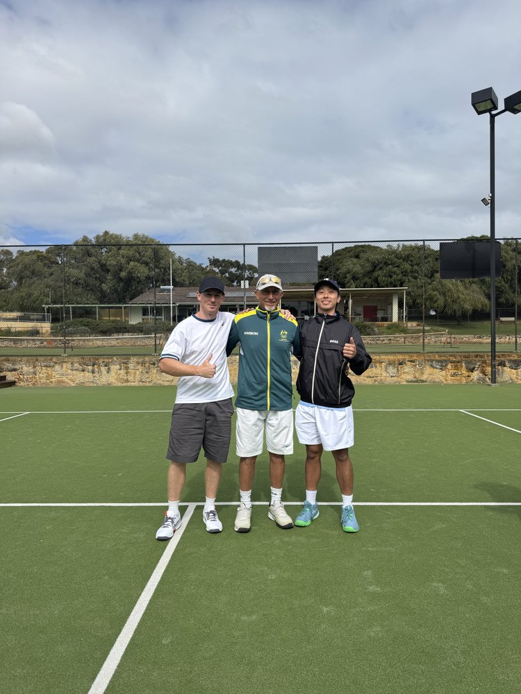 Three players on a grass court