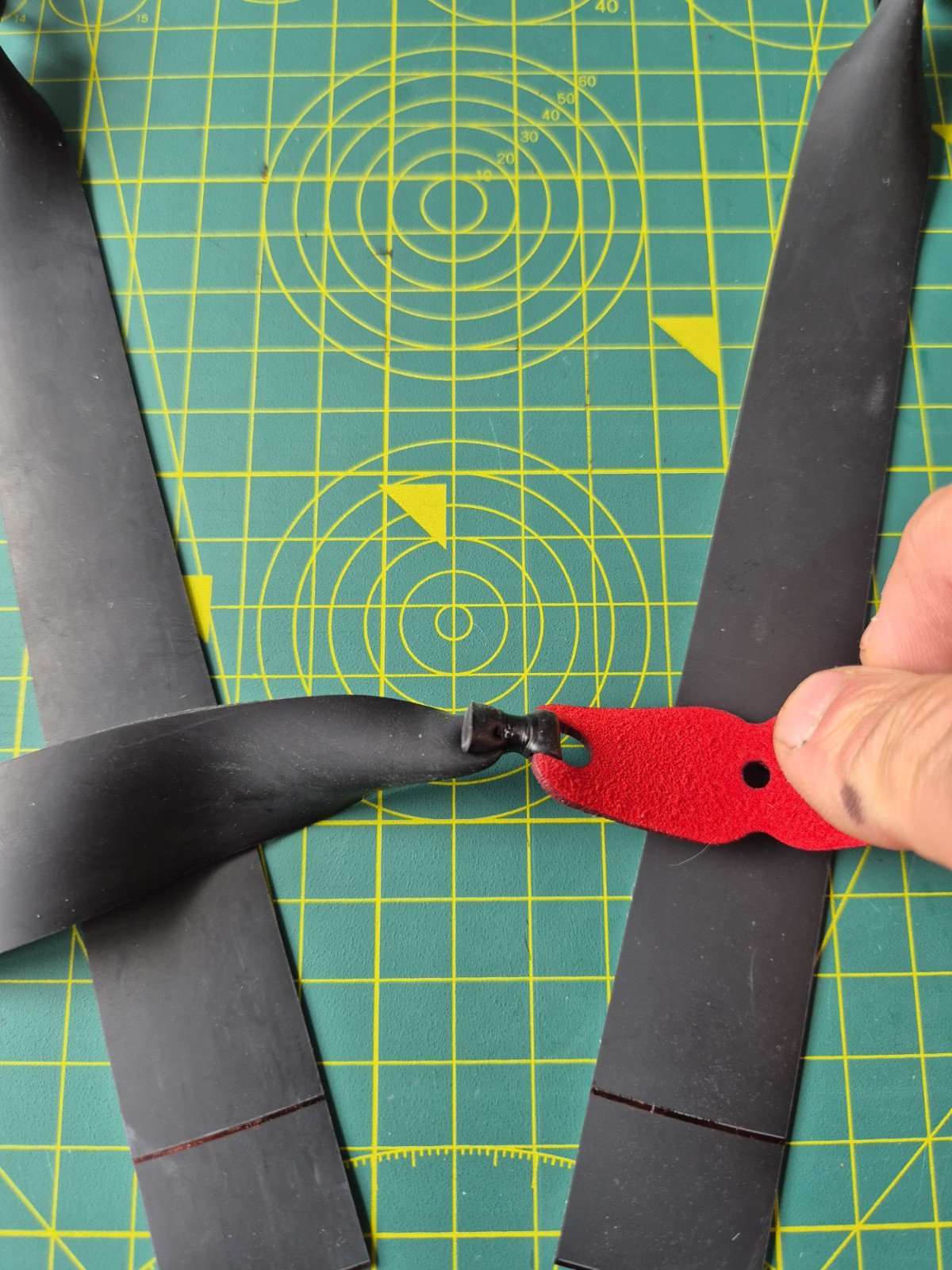 Close-up detail of a precise, hand-tied red microfiber pouch on a custom flat band set.
