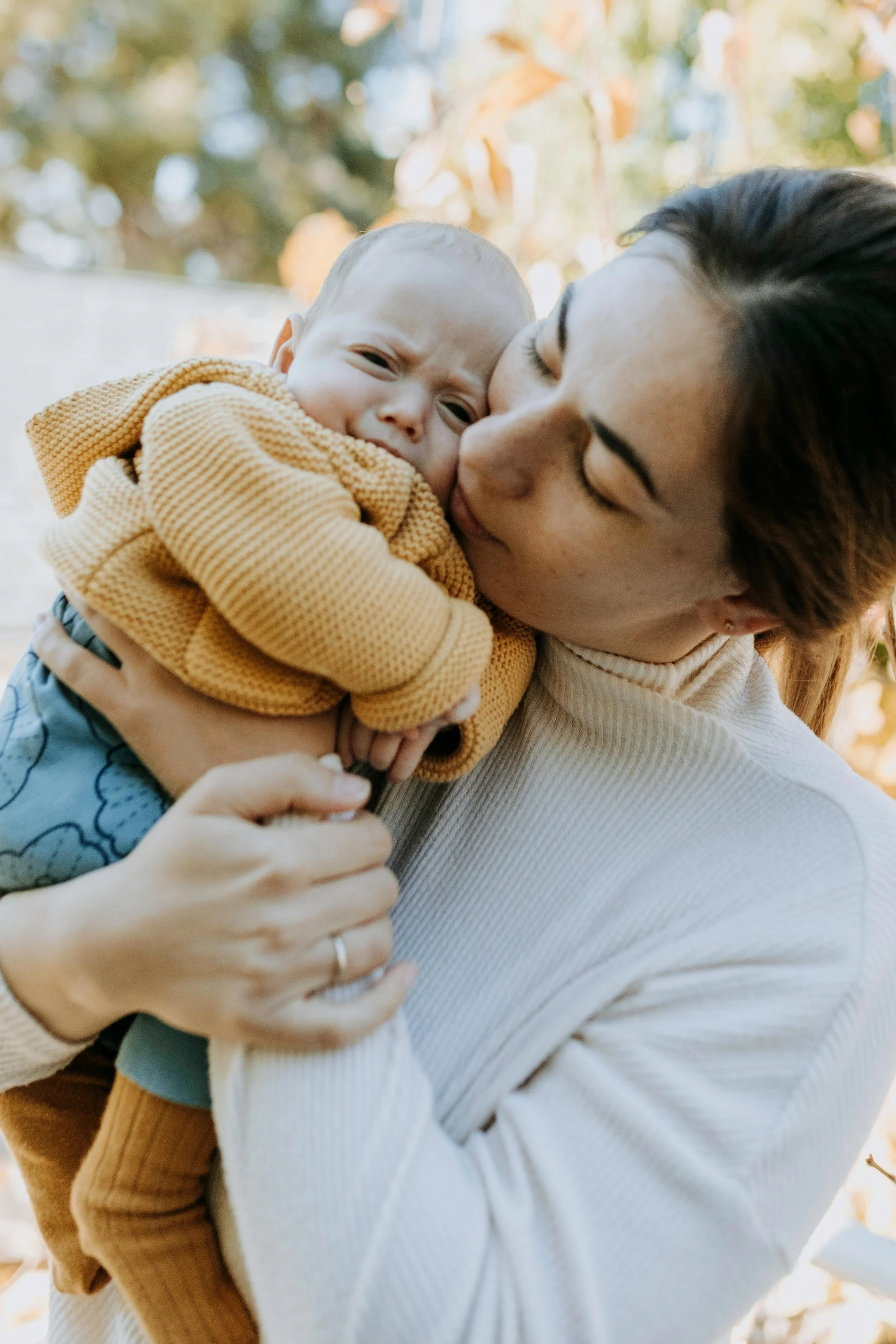 Mom and newborn snuggling together outside because Strong Roots Occupational Therapy provides in-home maternal health and infant occupational therapy services in the southern New Jersey and Philadelphia areas