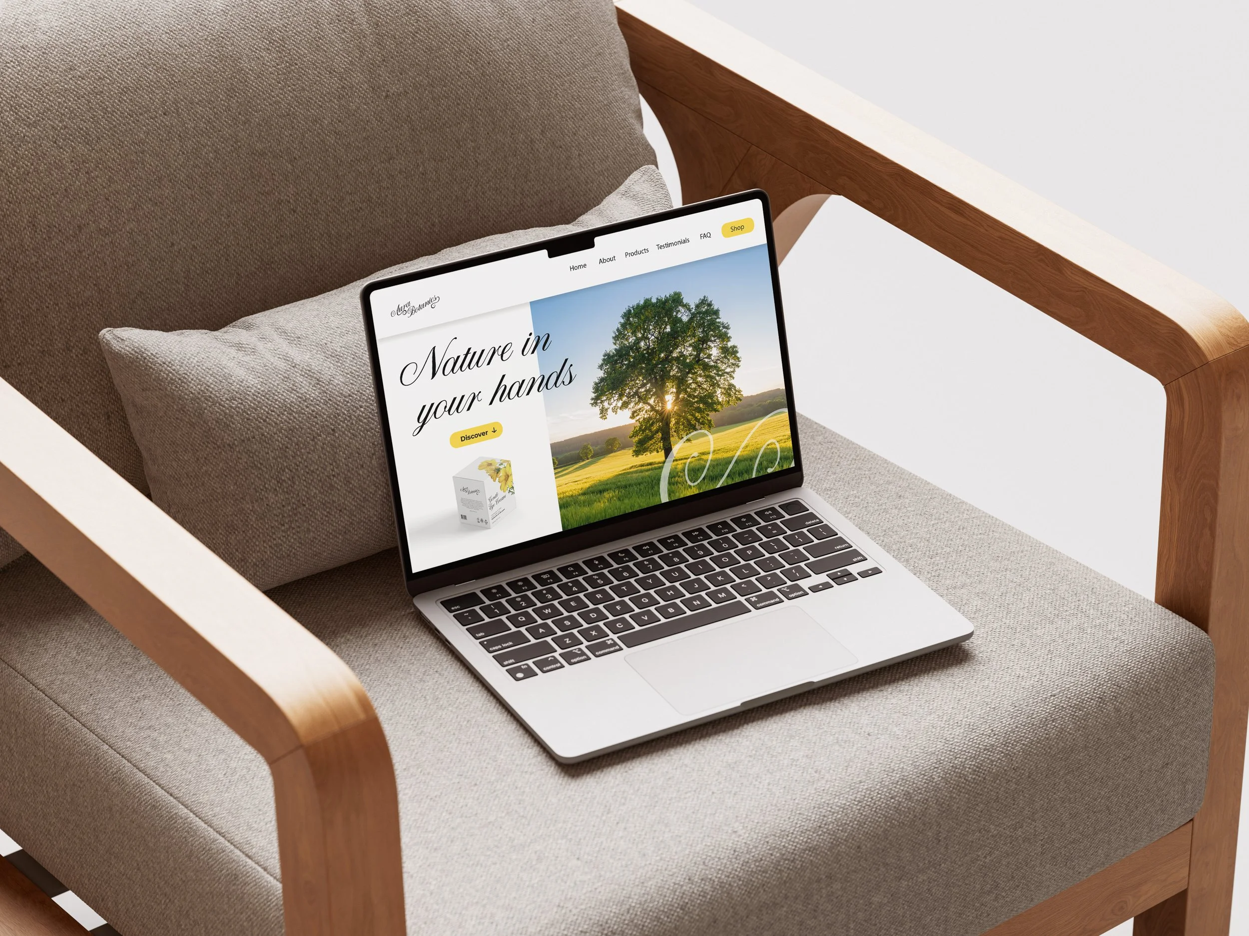 A laptop on a beige cushioned armchair showing a website titled 'Nature in your hands' with an image of a tree against a blue sky in the background.