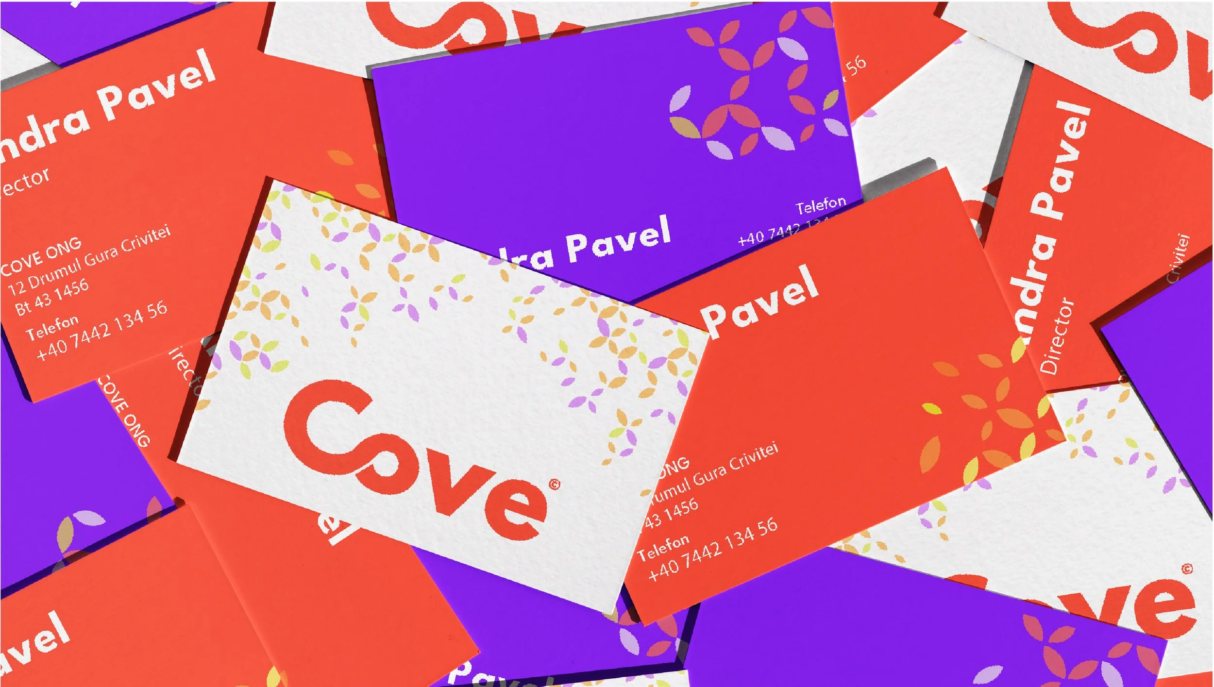 A collection of colorful business cards scattered, with purple, orange, and white backgrounds. Some cards feature contact details, including a name 'Kandra Pavel' and phone number, while another prominently displays the word 'Cove' in red with decorative leaf patterns.
