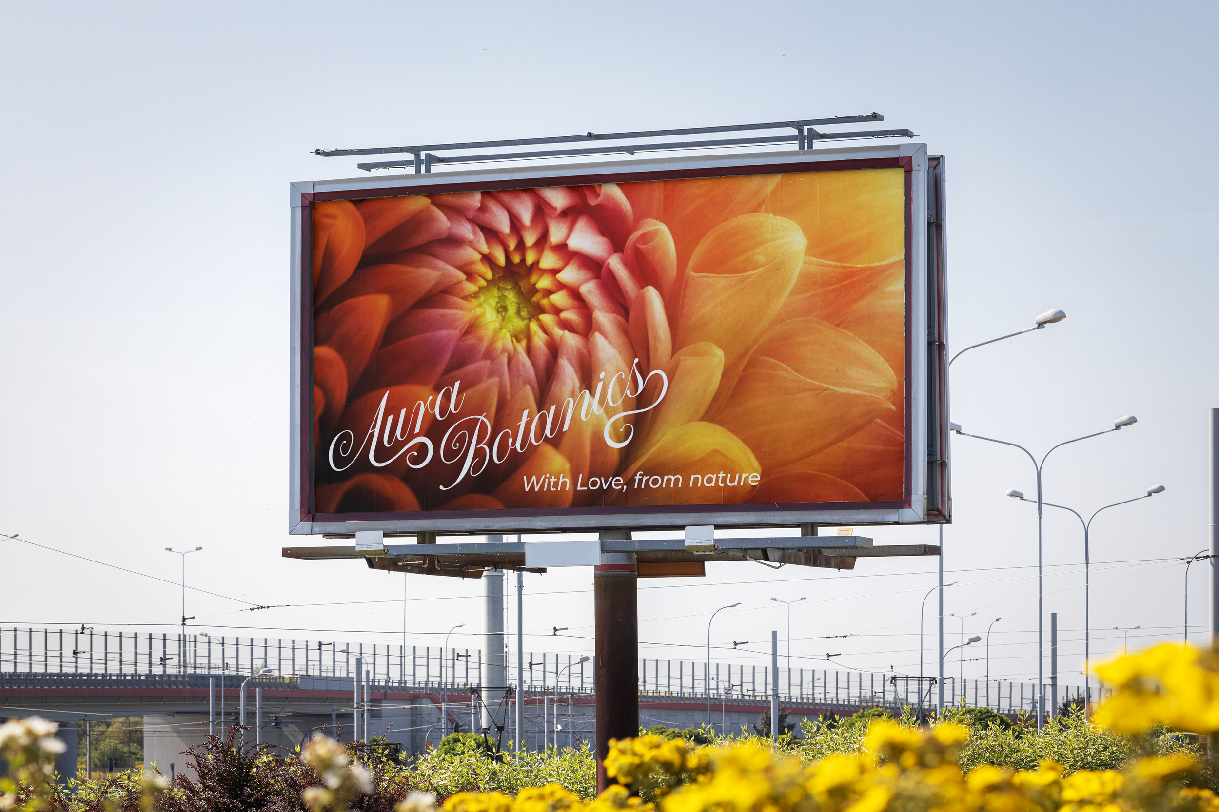 Billboard advertising Aura Botanica with vibrant orange and pink flower imagery and the slogan 'With Love from nature'.