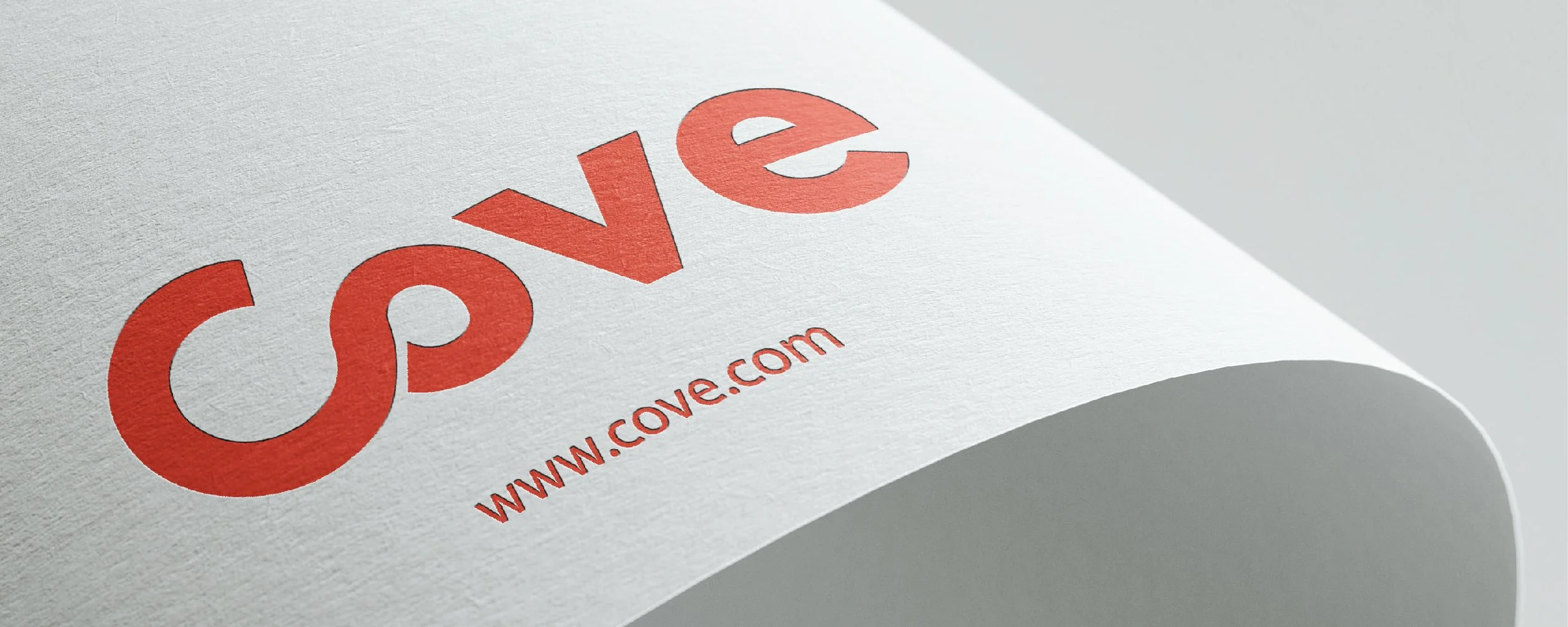 Close-up of a printed paper with the red website logo 'cove' and the URL www.cove.com beneath it.