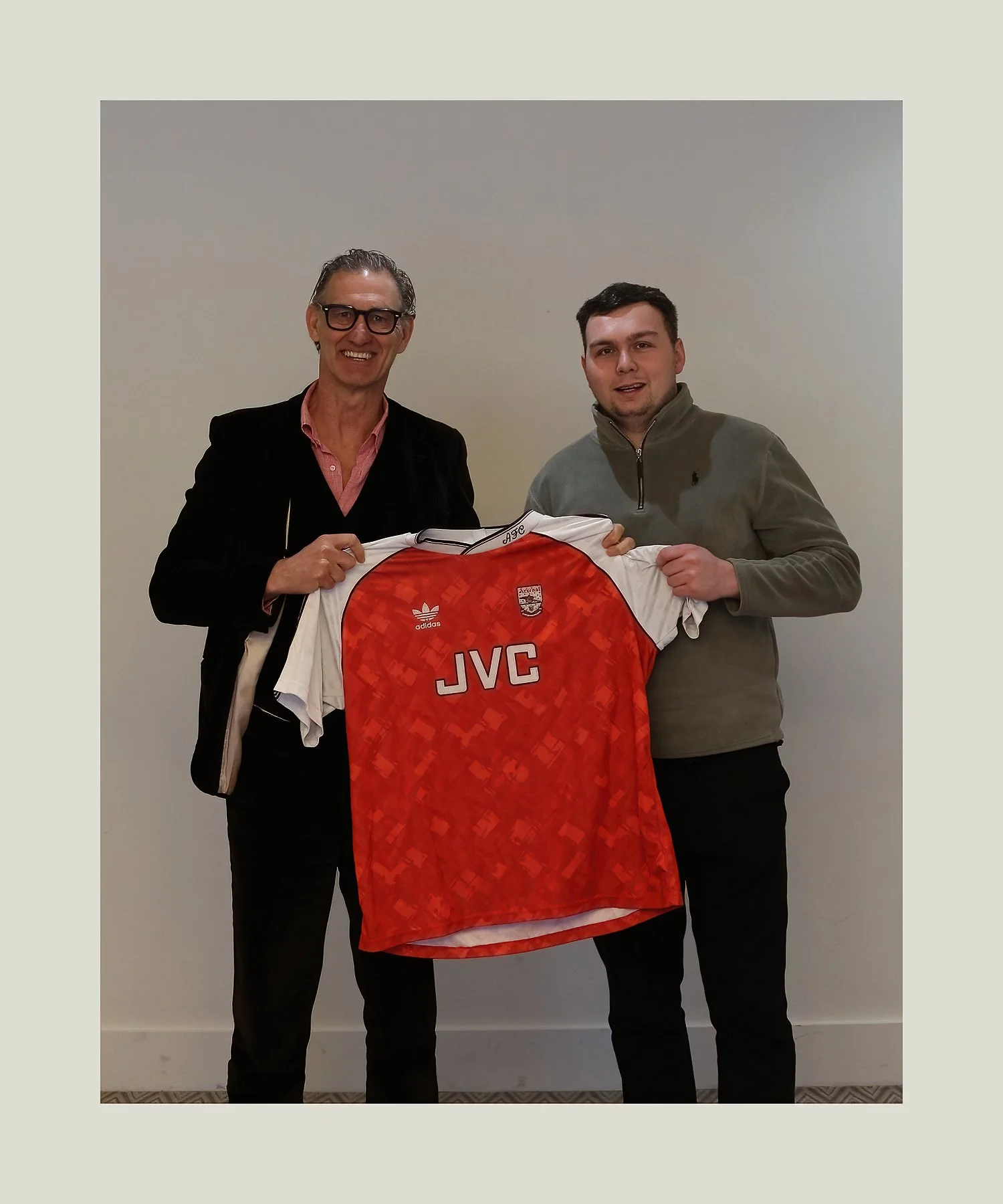 footballer tony adams MBE holding a arsenal football club shirt