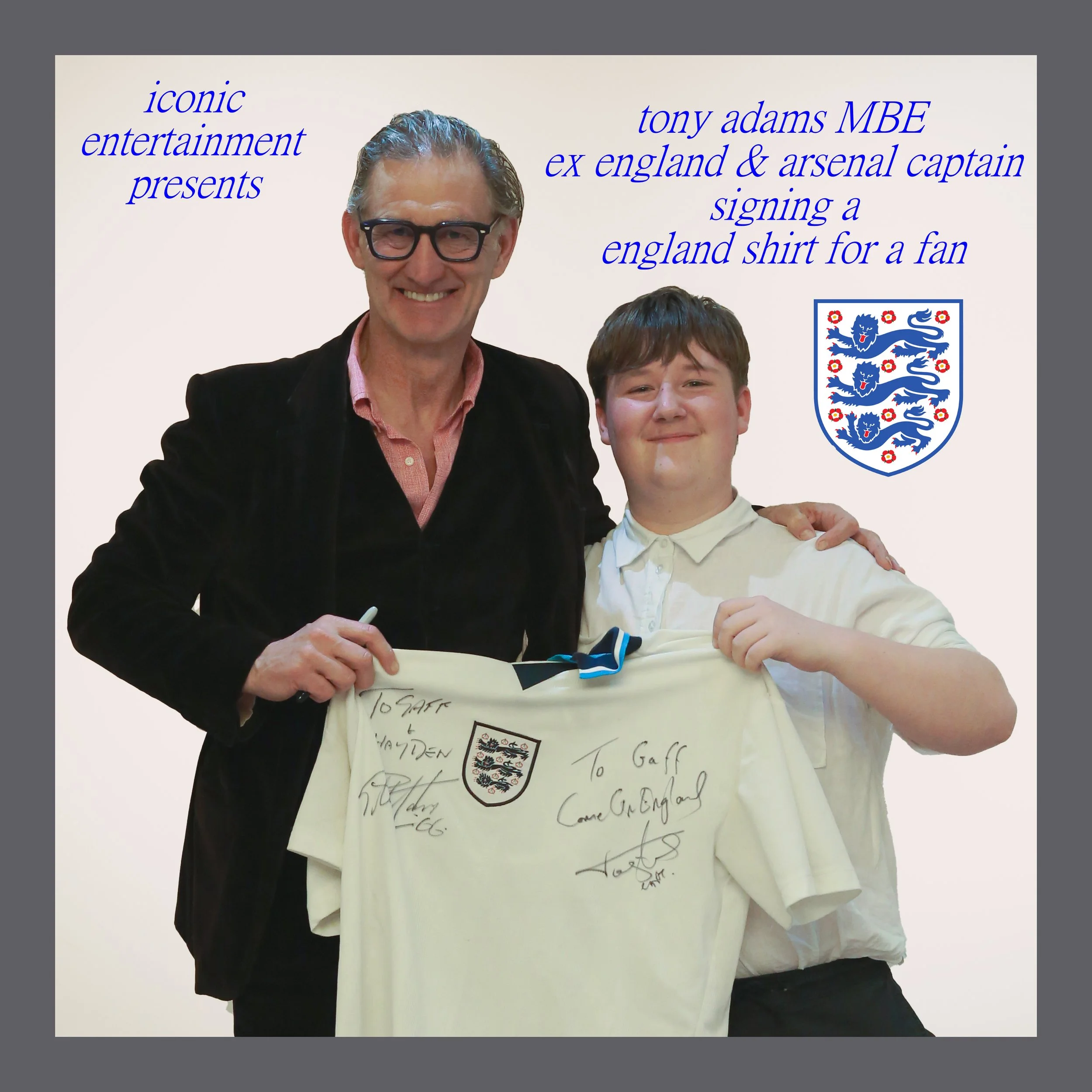 Tony Adams, former England and Arsenal captain, signs an England shirt for a fan, a young man, with a white background including the England crest and blue text describing the event.