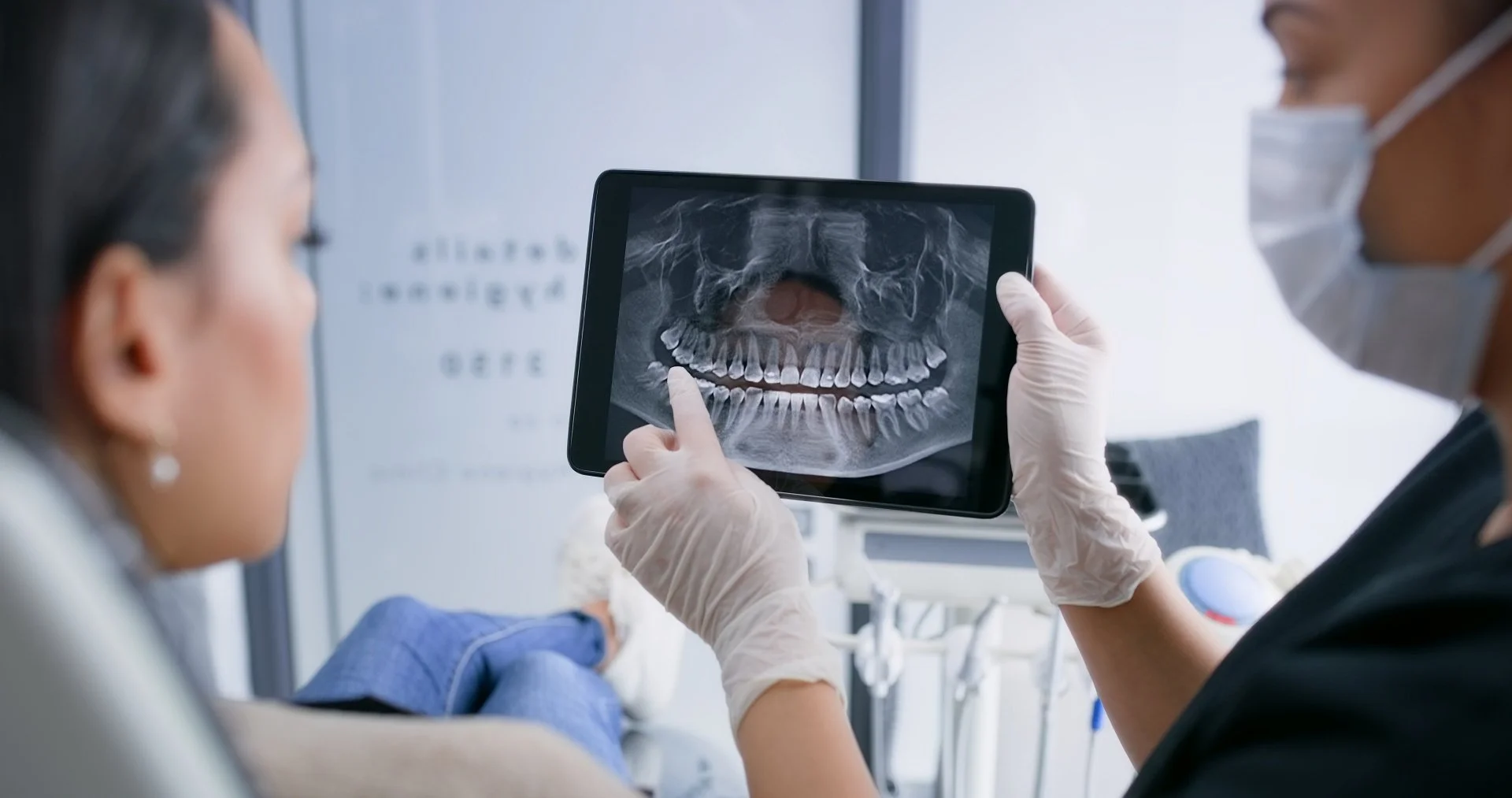 Dentist explaining a panoramic dental X-ray during a wisdom teeth consultation at Innova Dental in Toronto.