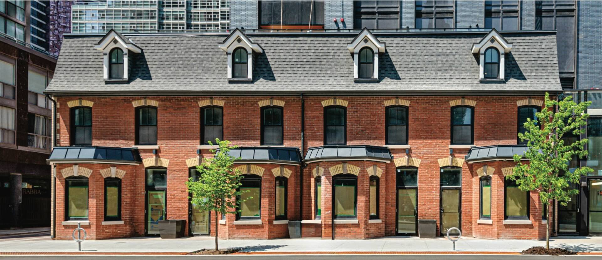 Thomas Bryce Row, 10–16 Wellesley Street West, downtown Toronto — the heritage-designated Second Empire facade that houses Innova Dental. Built 1876, designated under the Ontario Heritage Act 2020, Heritage Toronto 2024.