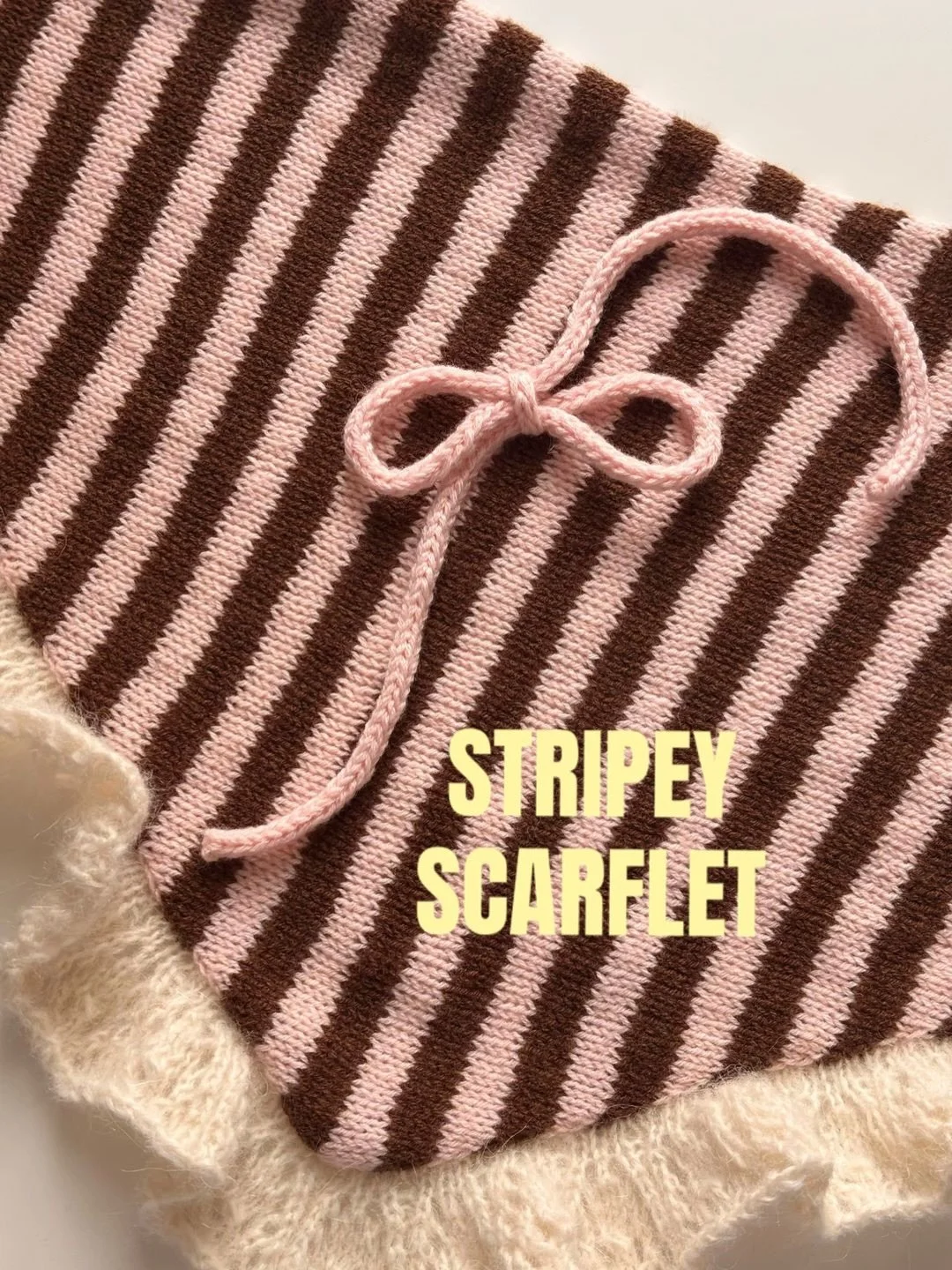 Hi! I am finally looking for five testers for my first ever pattern, the Stripey Scarflet 💗🤎 

This playful striped triangle scarf is the perfect addition to any outfit, and the lace ruffle adds just that needed extra layer of dreaminess. The Scarf