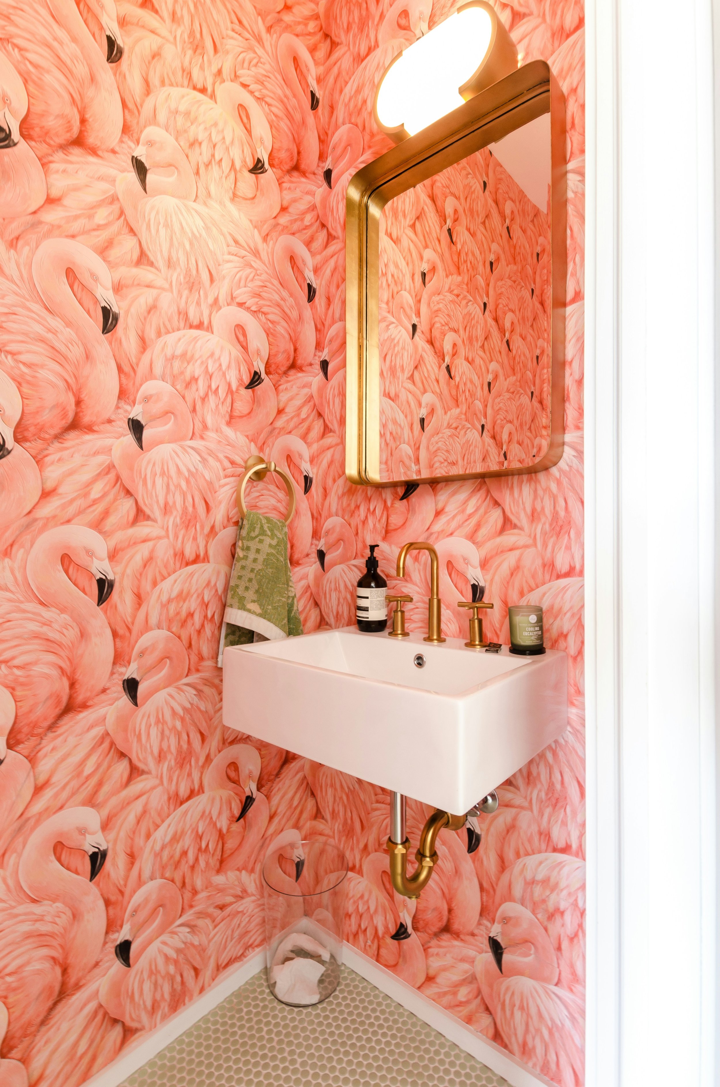 Dramatic pink flamingo wallpaper in a small cloakroom