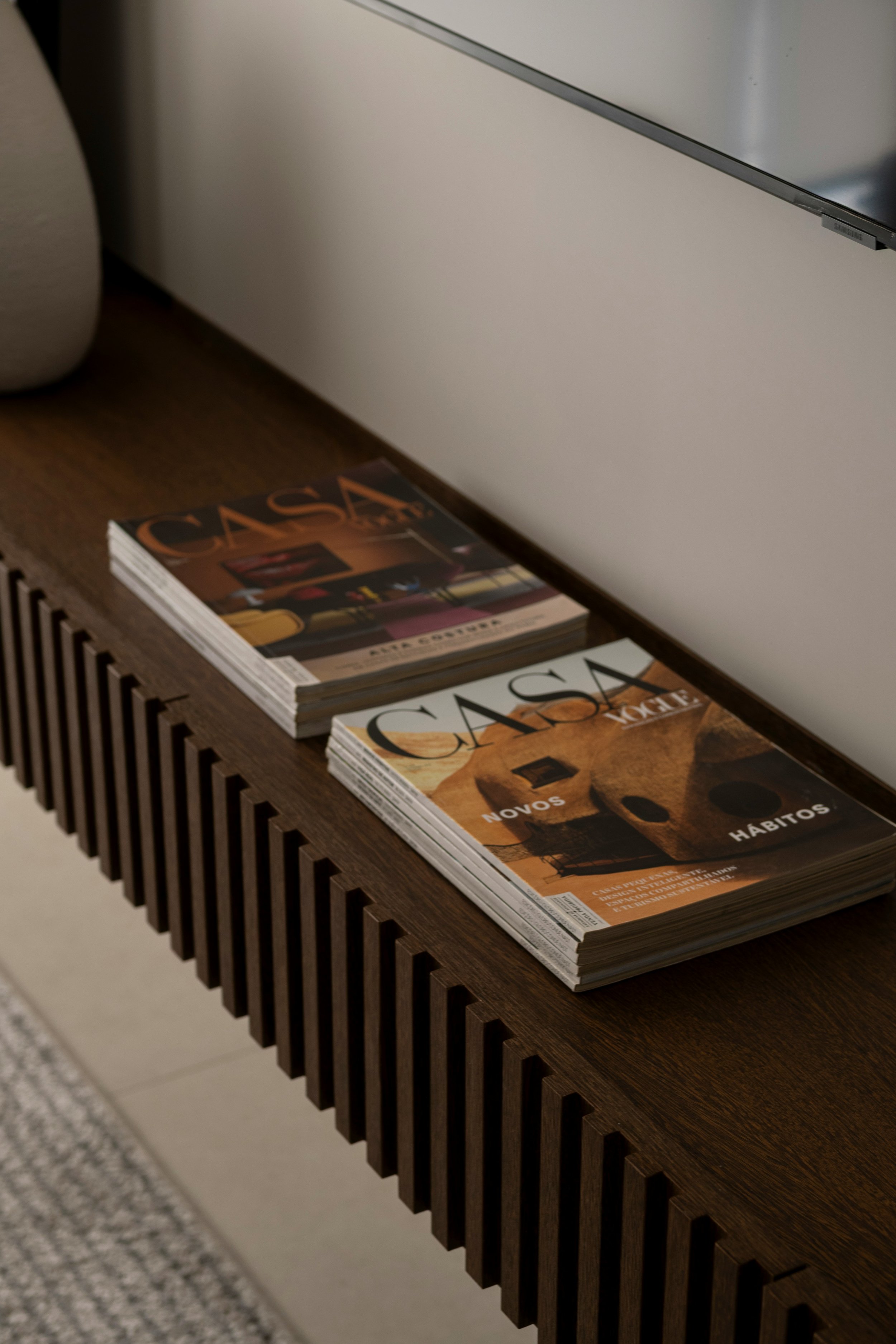 Interior design magazines in a stack on a sideboard