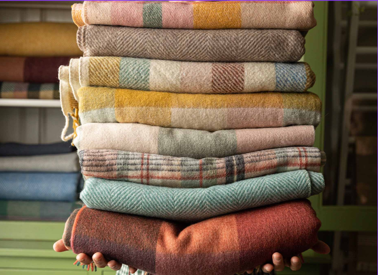 Stack of warm wool blankets in autumn colours