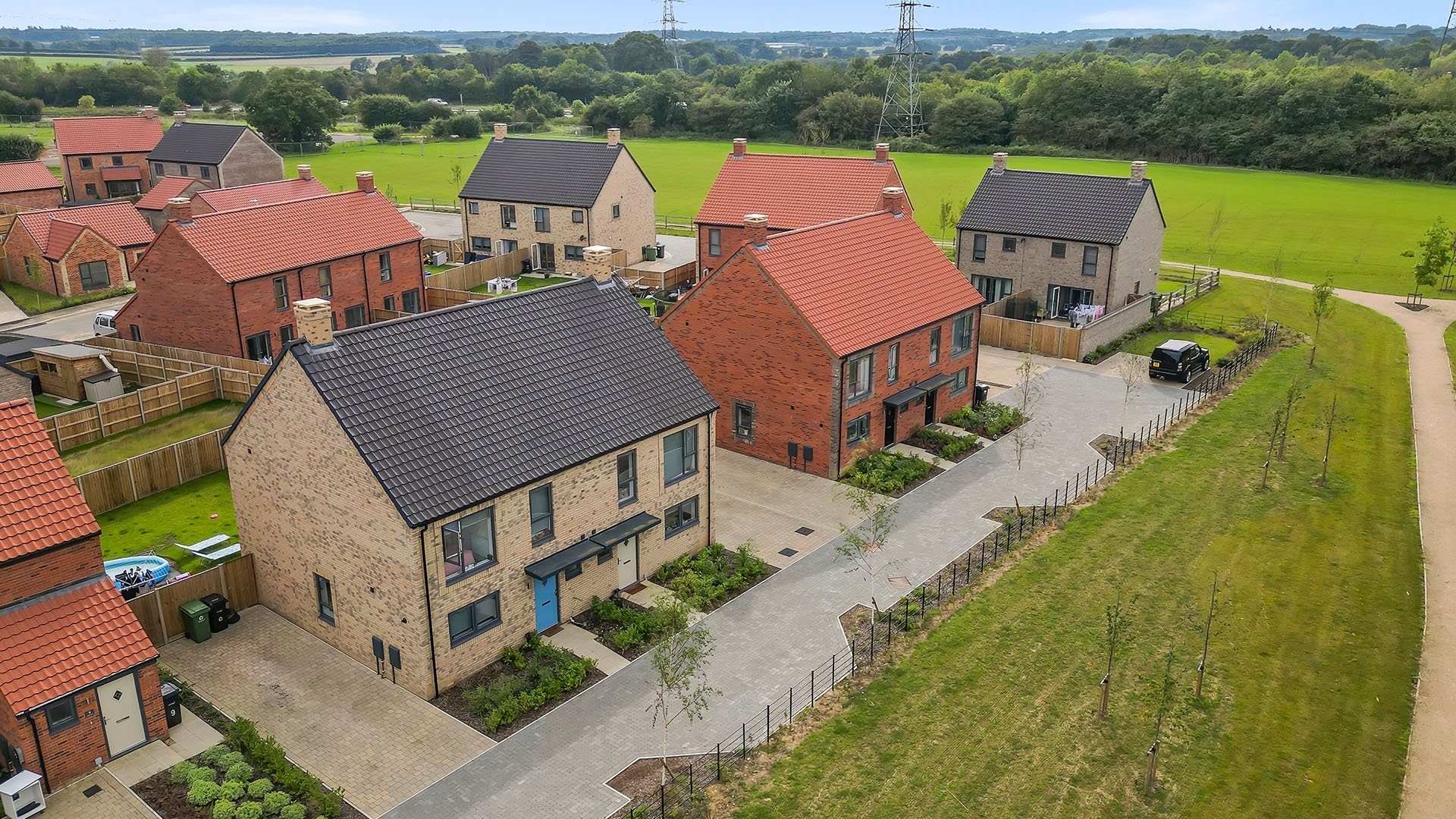 Aerial view of mixed homes and landscaped streets at St. Giles Park