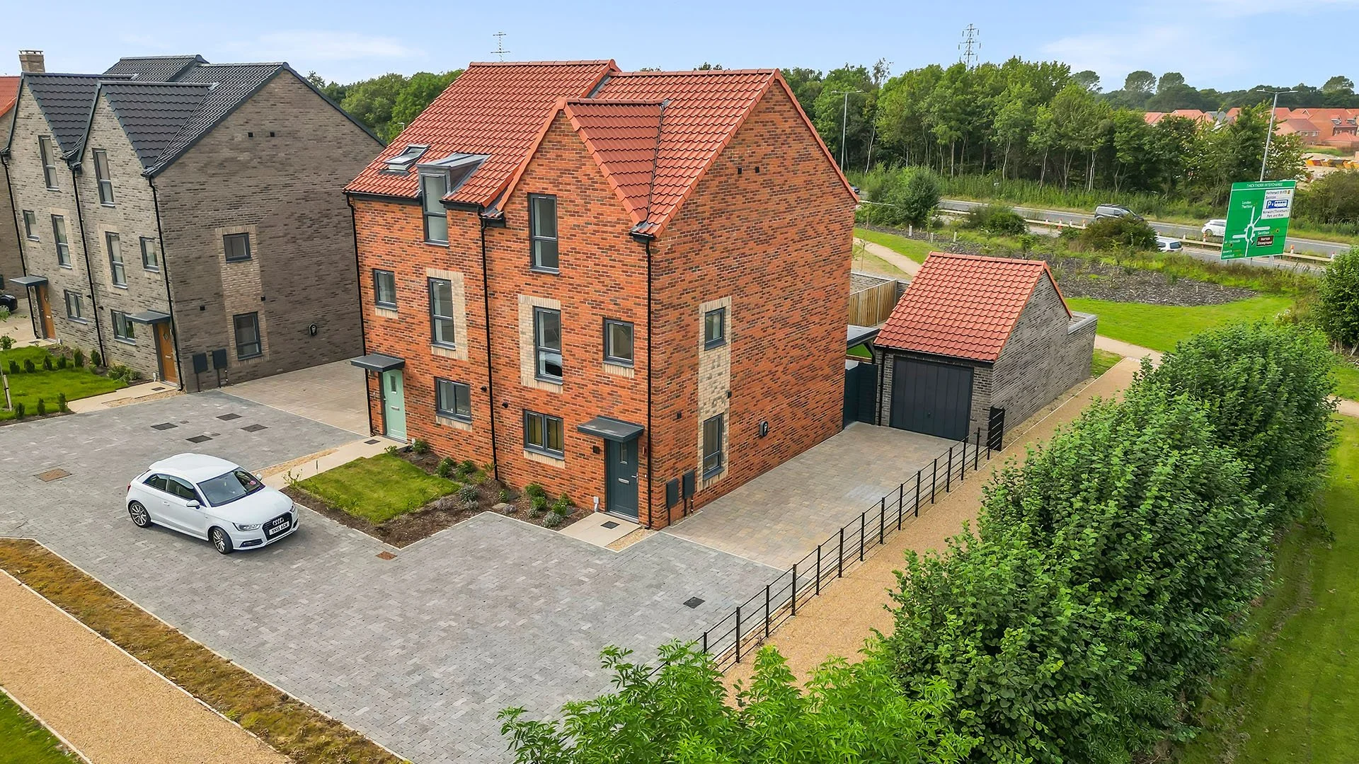 Red-brick apartment buildings and parking at St. Giles Park