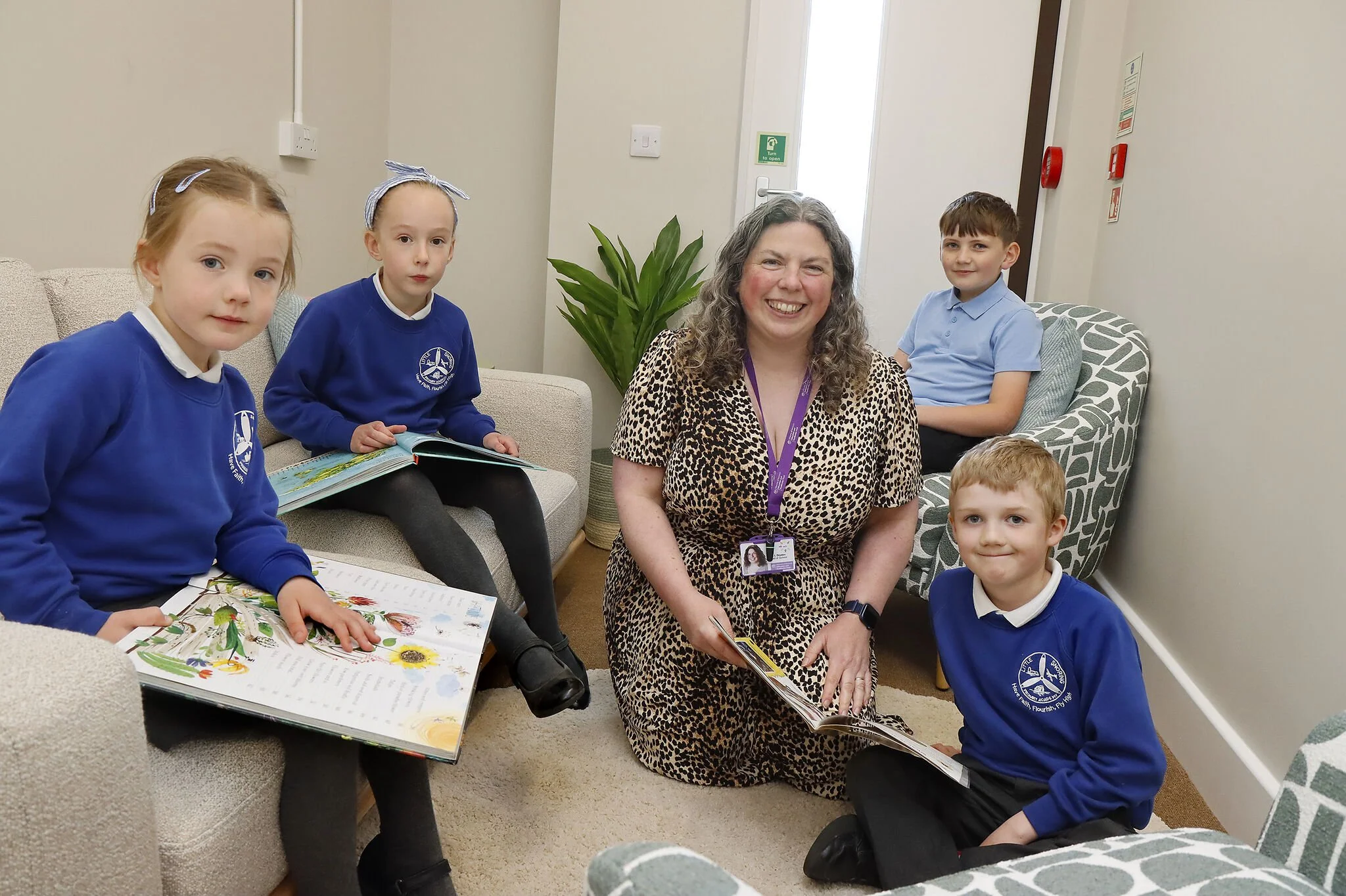 Teacher and students reading books in classroom