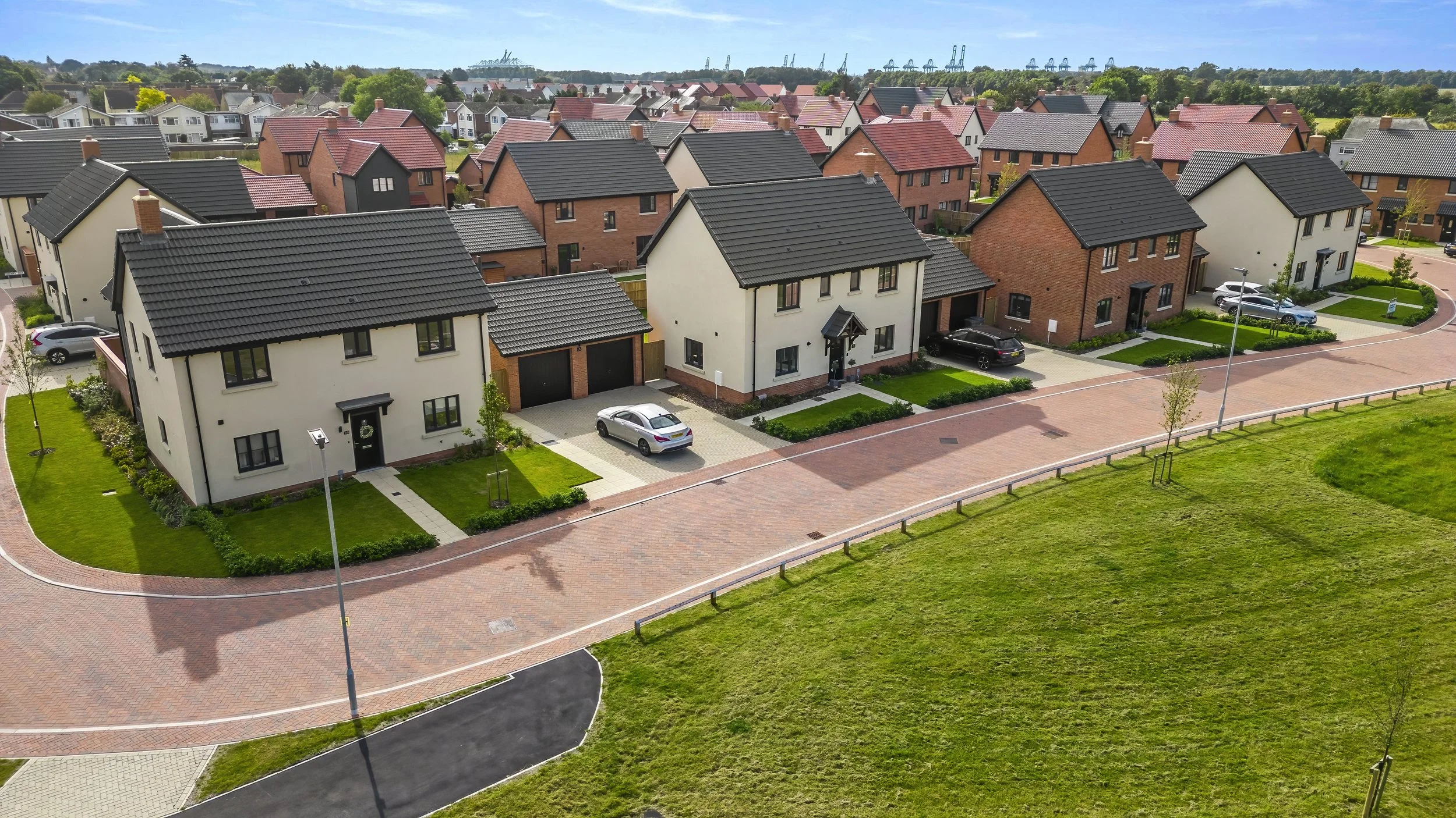 Rendered homes with red-tiled roofs at The Lilacs