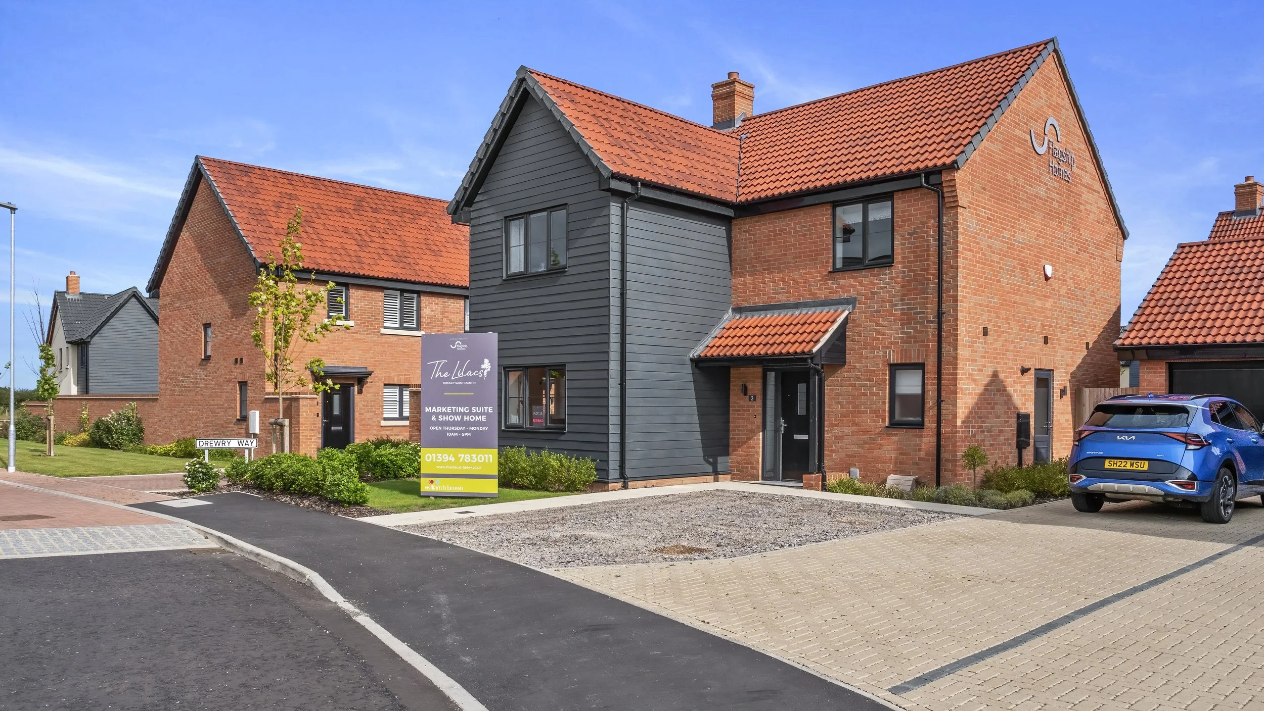Contemporary red-brick homes and parking at The Lilacs
