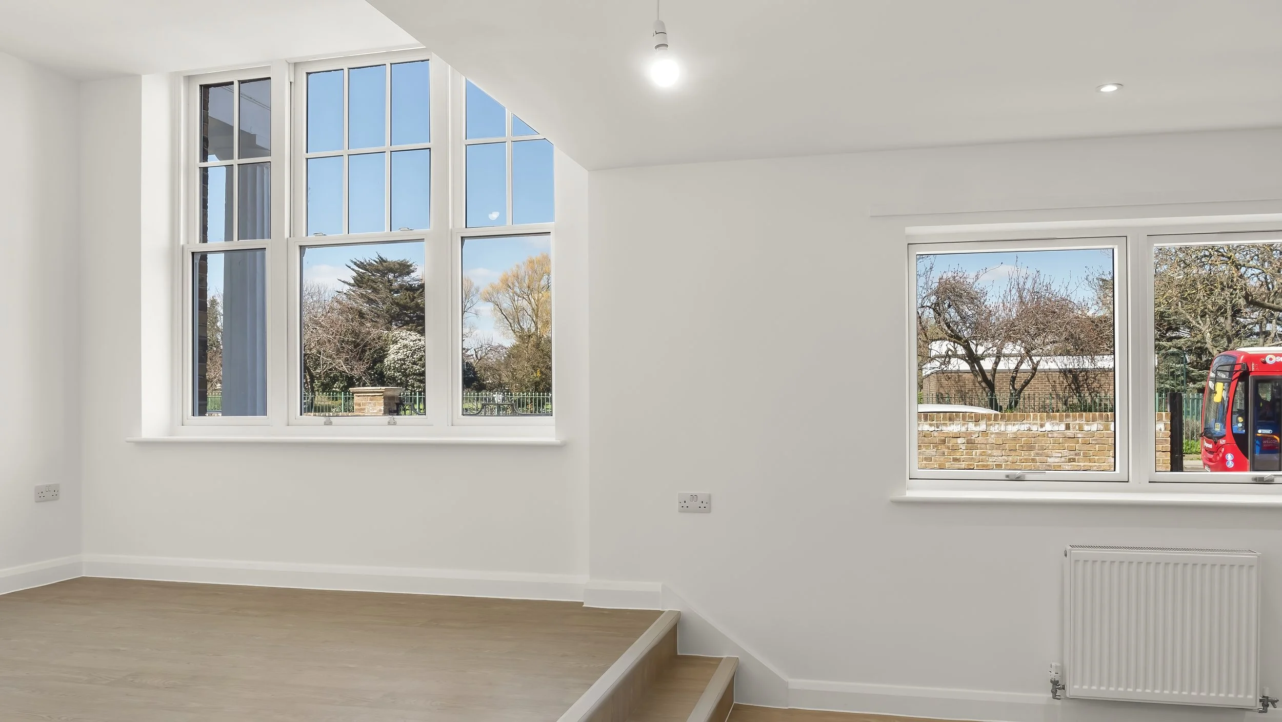 Bright living area with original sash windows at Loxford Hall