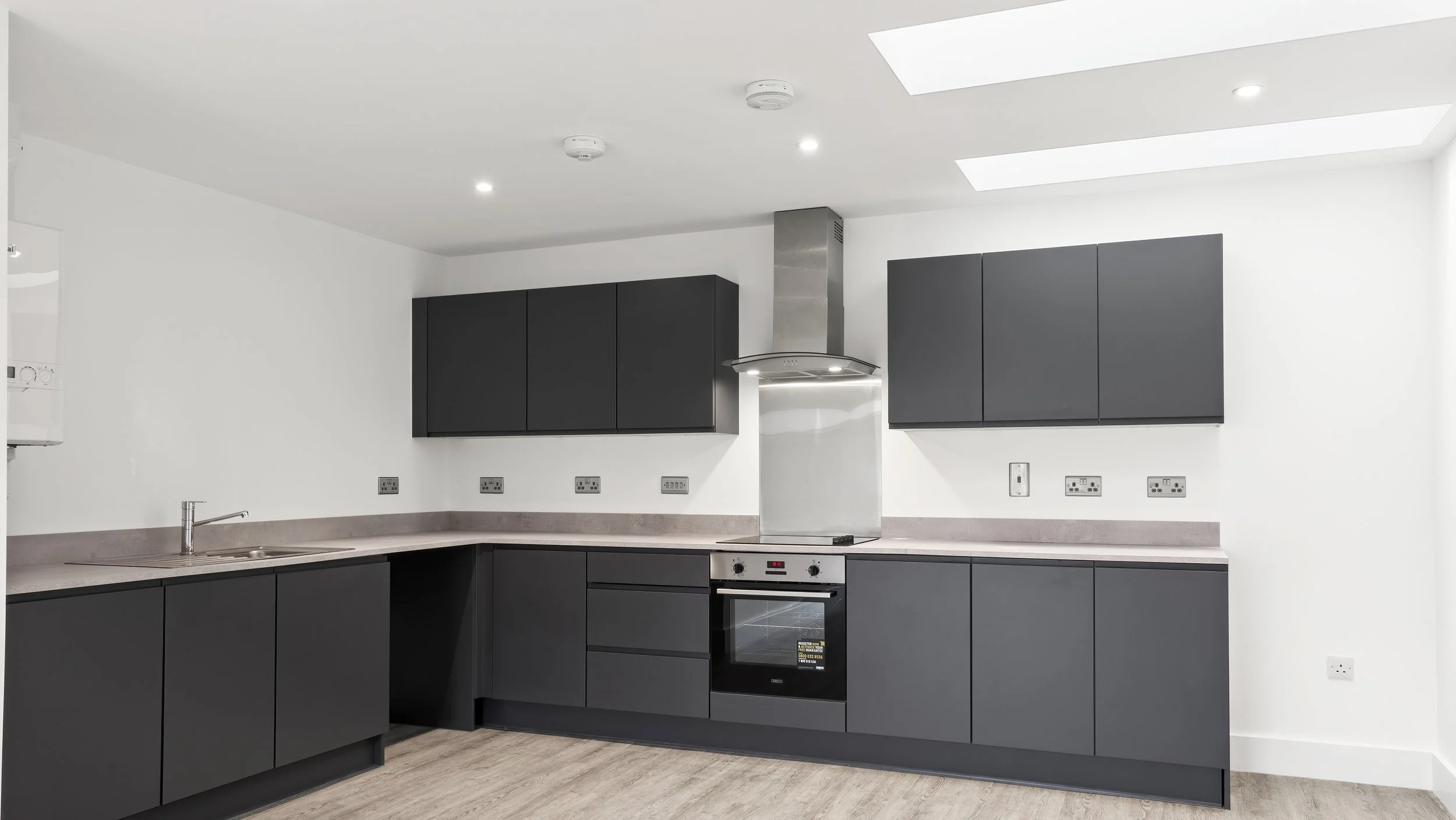 Dark-grey fitted kitchen inside Wamil Court