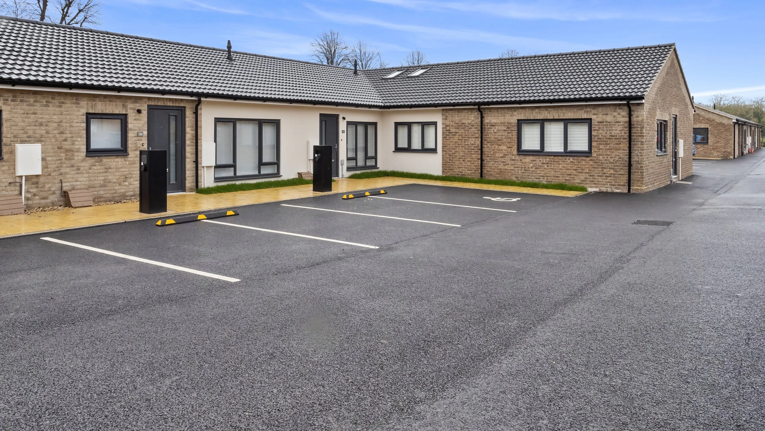 Single-storey Wamil Court homes and parking spaces