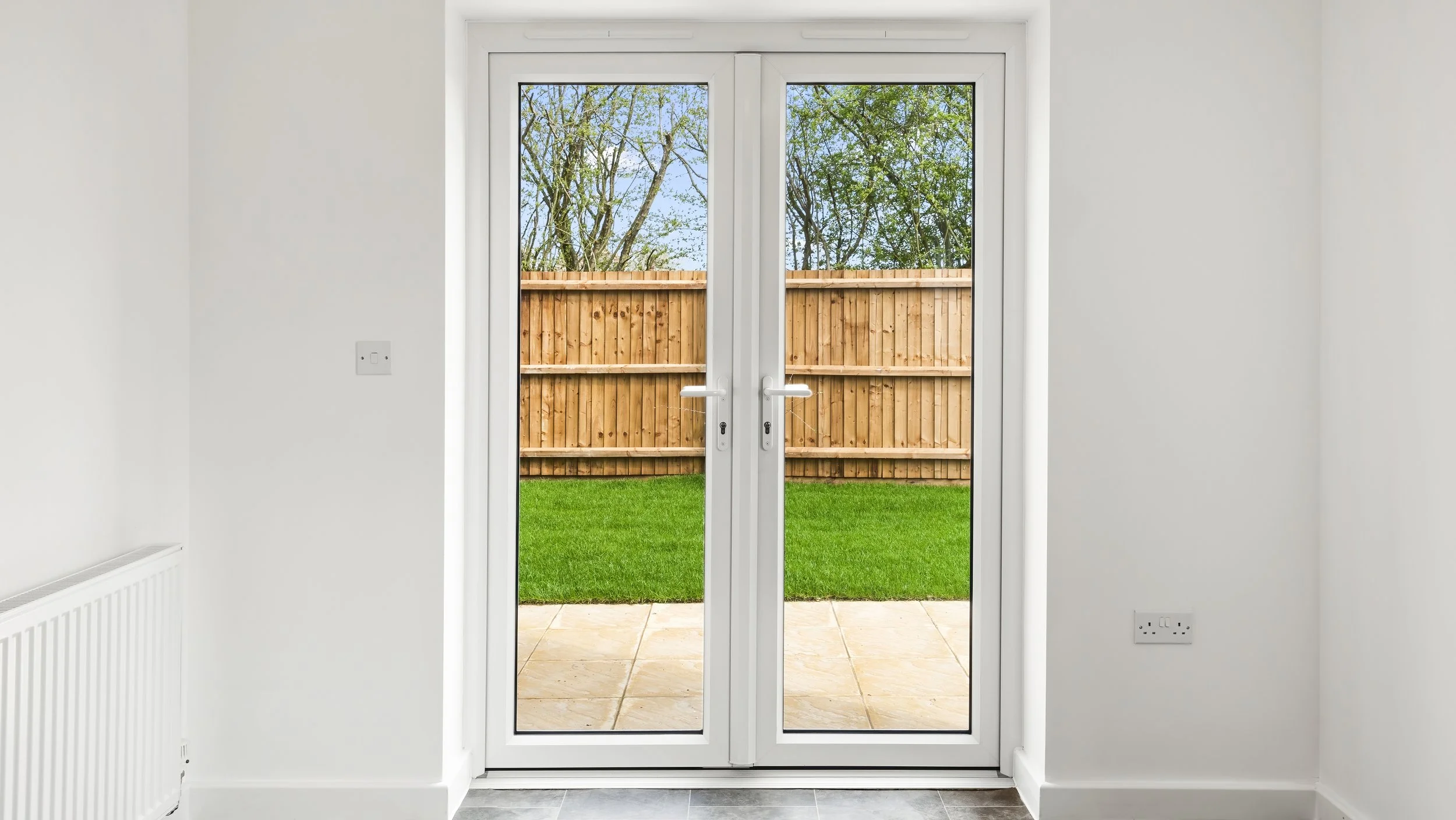 Bright room with patio doors to a garden at Great Staughton