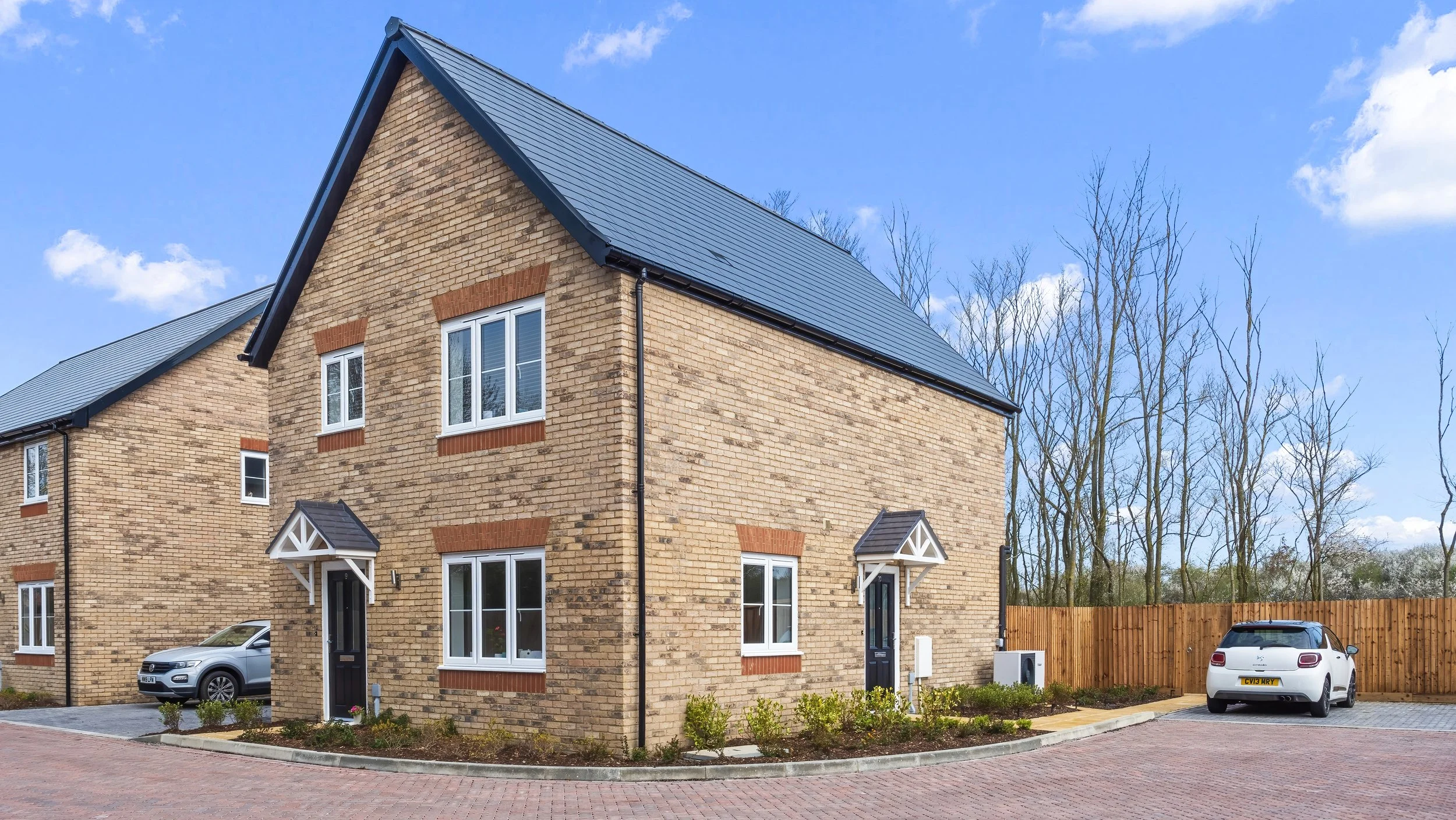 Pair of light-brick homes on the Great Staughton development