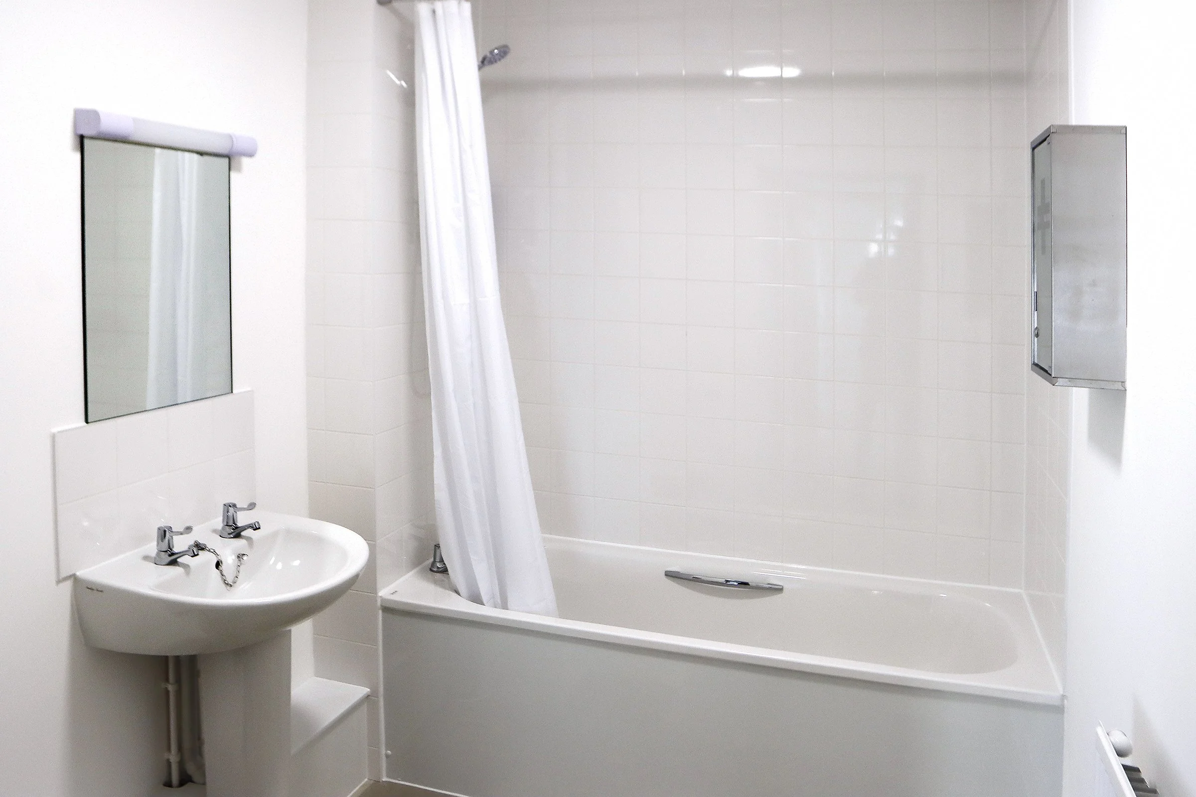 Bathroom with bath and shower inside Wade House