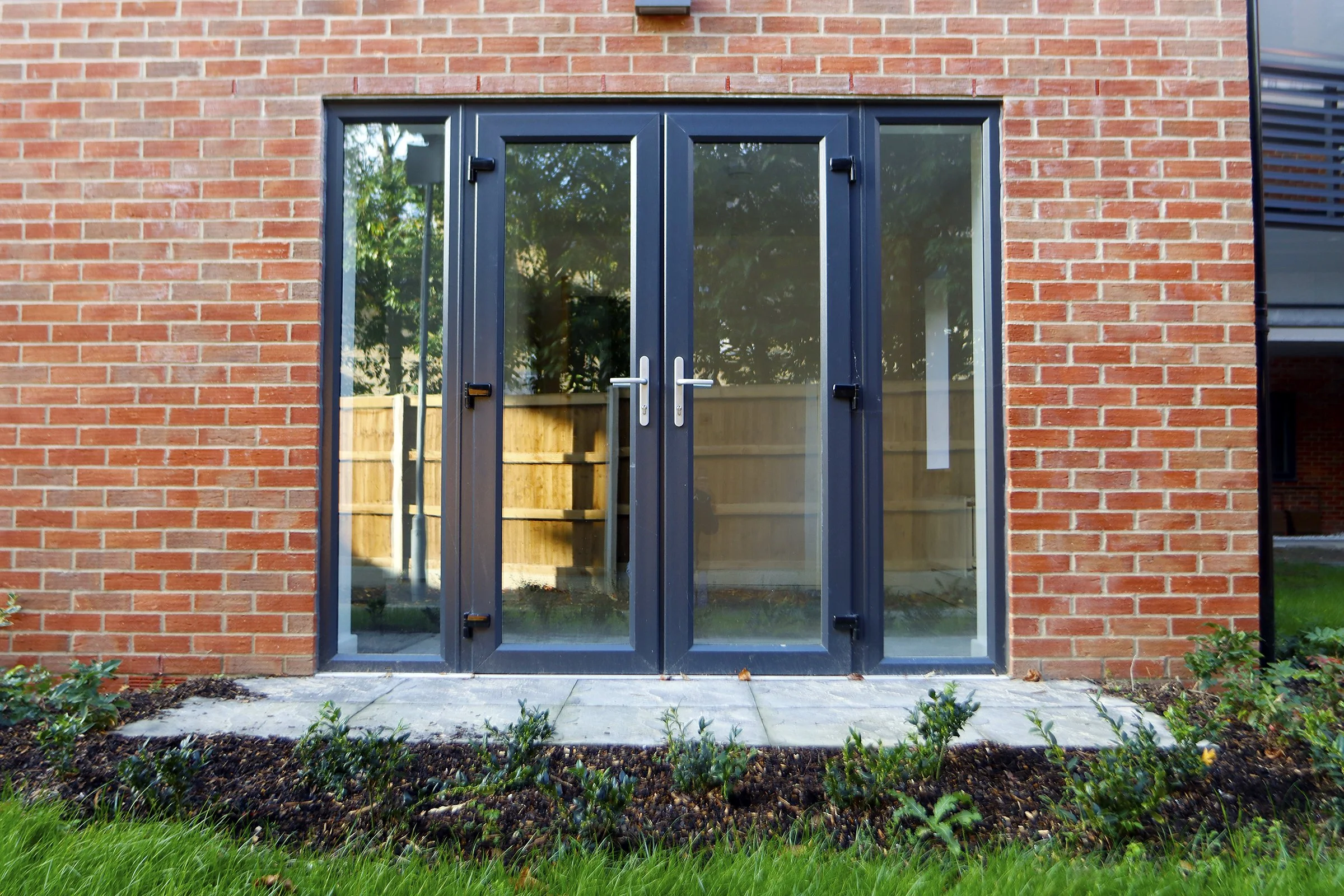 Black-framed patio doors and planting at Wade House