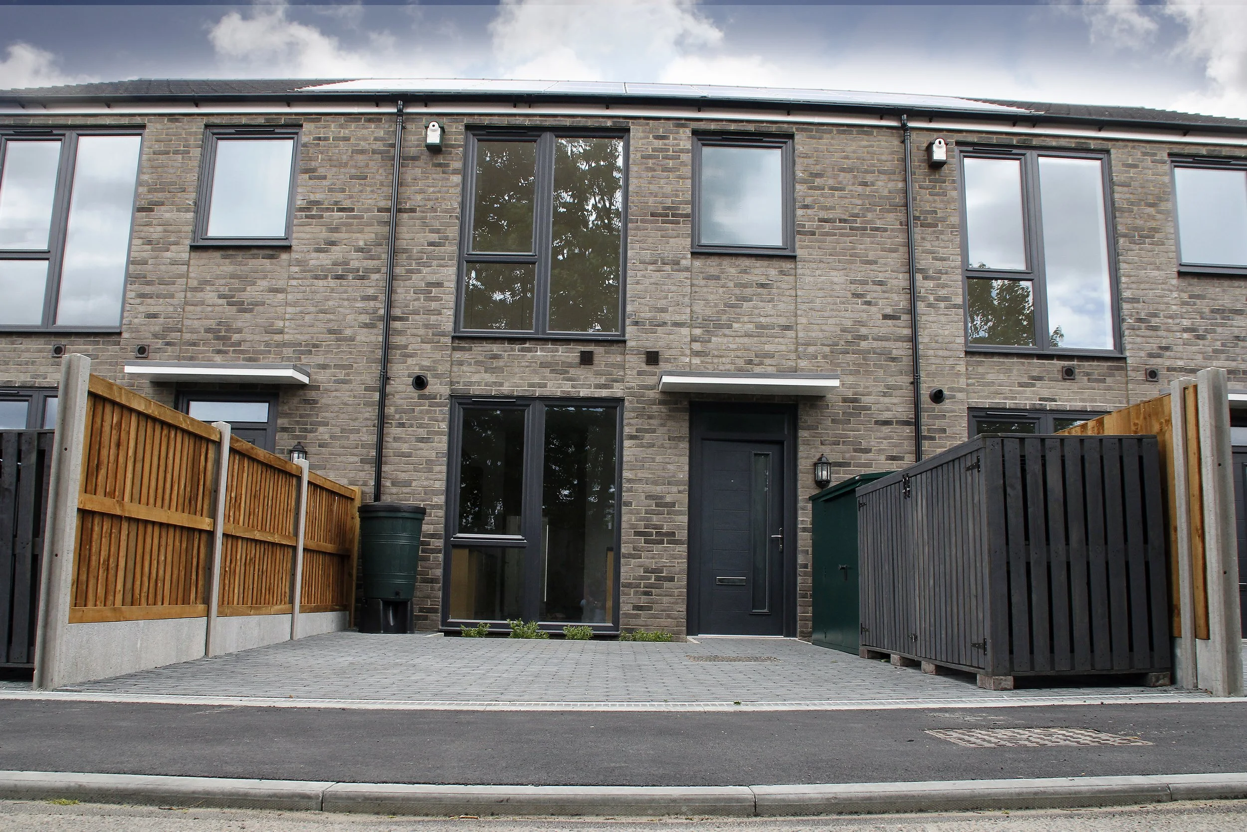Front elevations of brick-built homes at Wessex Close