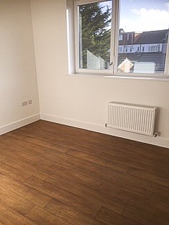Bright room with timber-effect flooring at Pershore Close