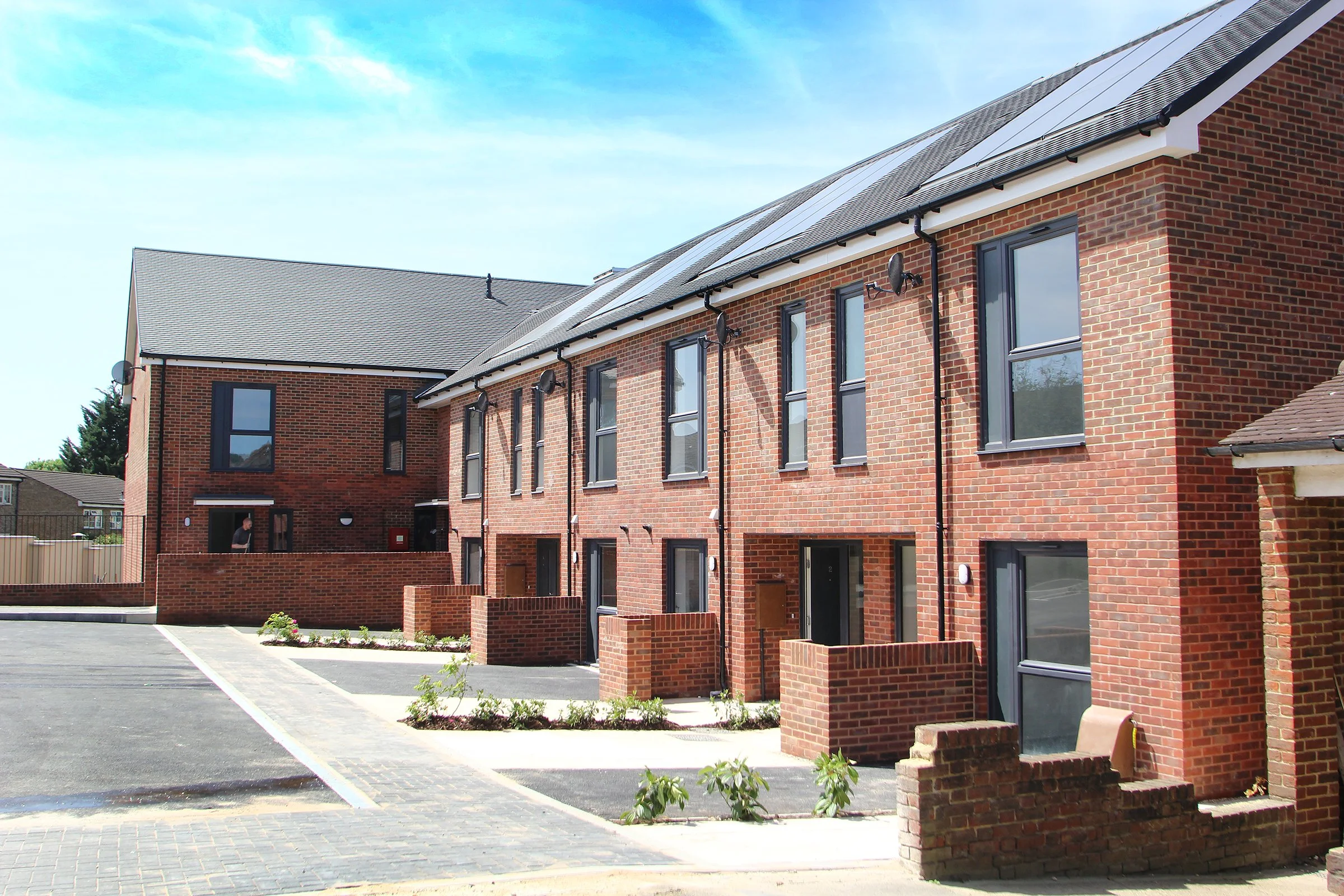 Brick apartment homes with solar panels at Coppice Path