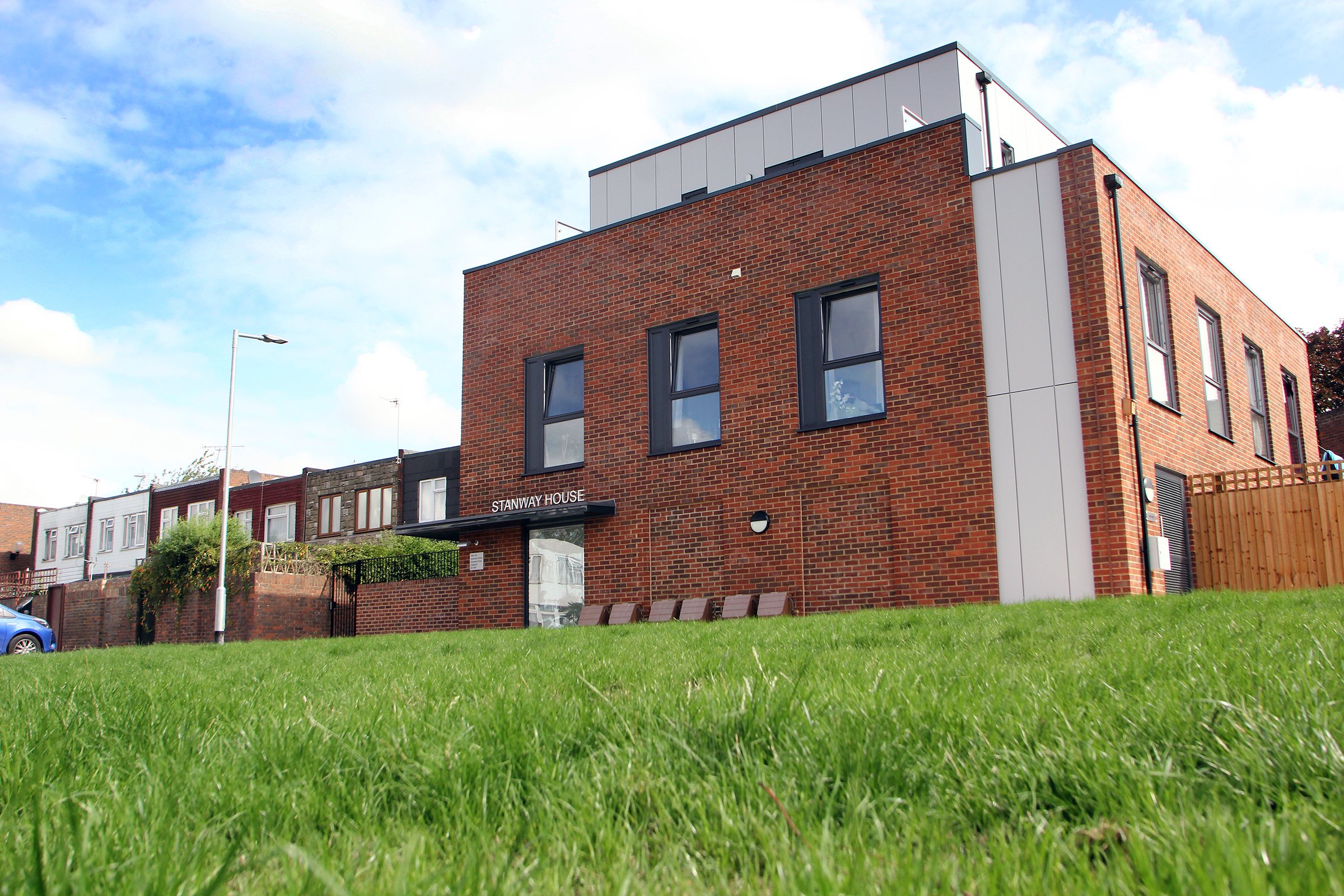 Side elevation of Stanway House beside landscaped grass