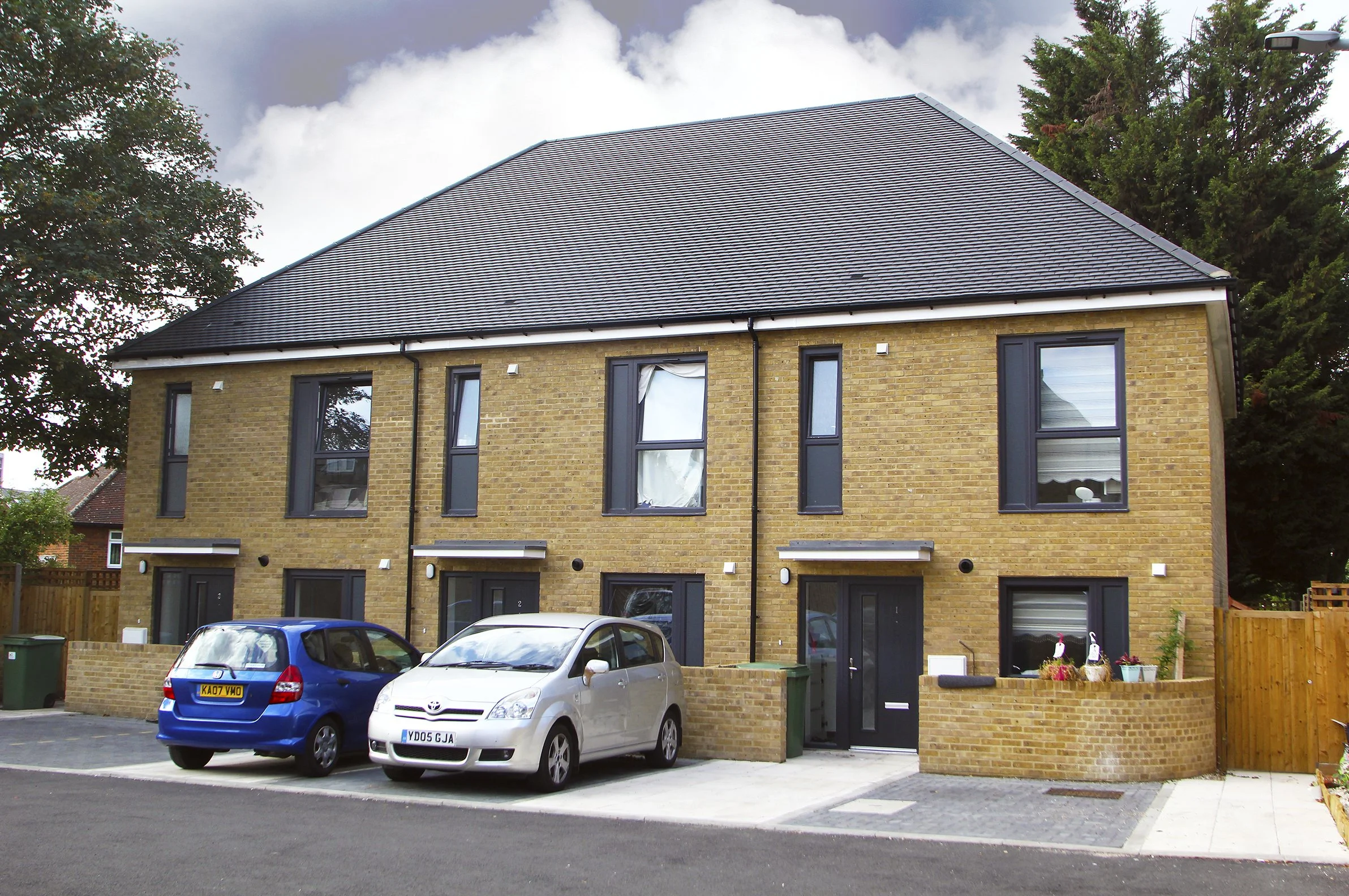 Terraced brick homes with resident parking at Rayleigh Road