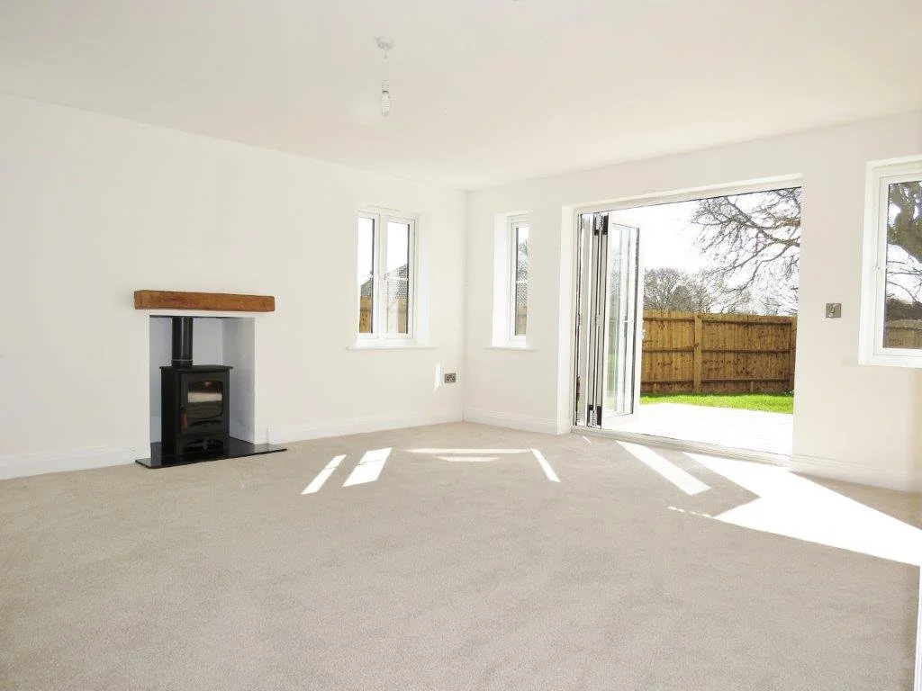 Sunlit living room with fireplace at Edward Marks Drive