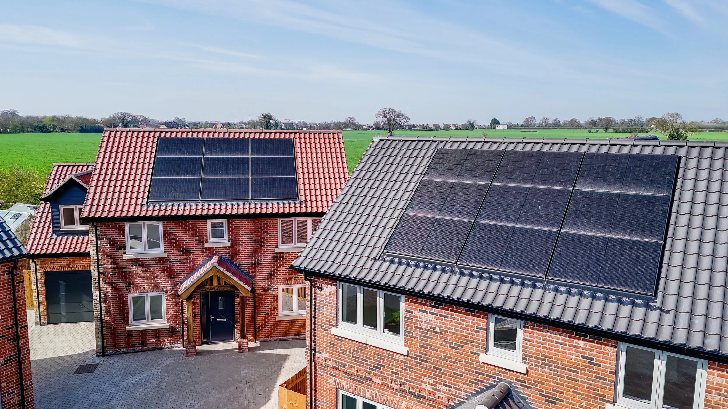 Elevated view of red-brick homes and rooftop solar panels at The Green